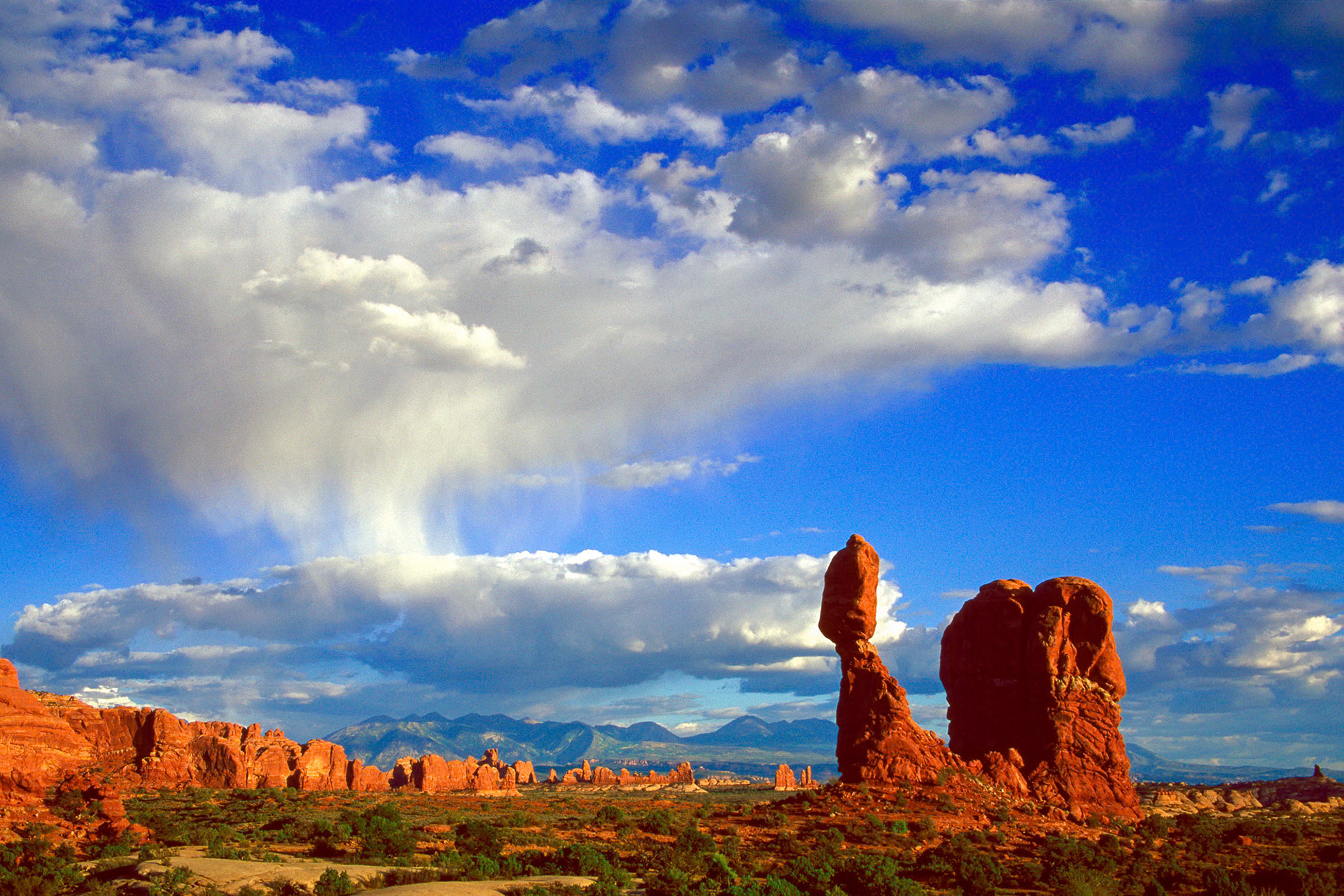 "Balanced Rock" - Balanced Rock at the Arches National Park, in Utah, USA is a majestic wonder of nature. On the left side of the photograph are clouds which form a virga, rain that evaporates before hitting the ground.