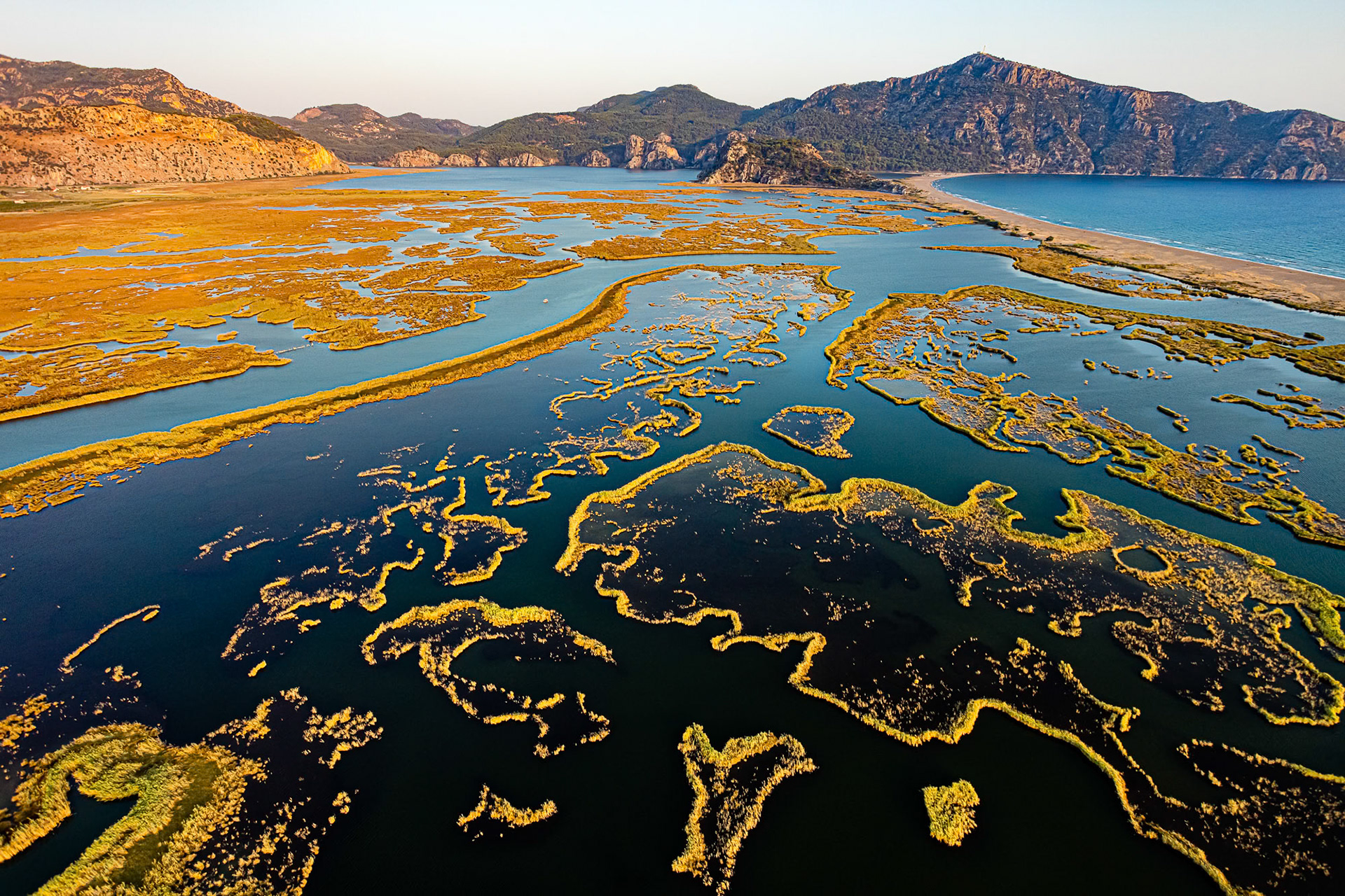 "Delicate Nature" - Iztuzu coast, a nesting place for sea turtles, and Dalyan with its maze of reeds are protected areas. I captured the brightly lit delicate reed lines contrasting with the dark water and the coastline at the magical sunset hour from my paramotor.