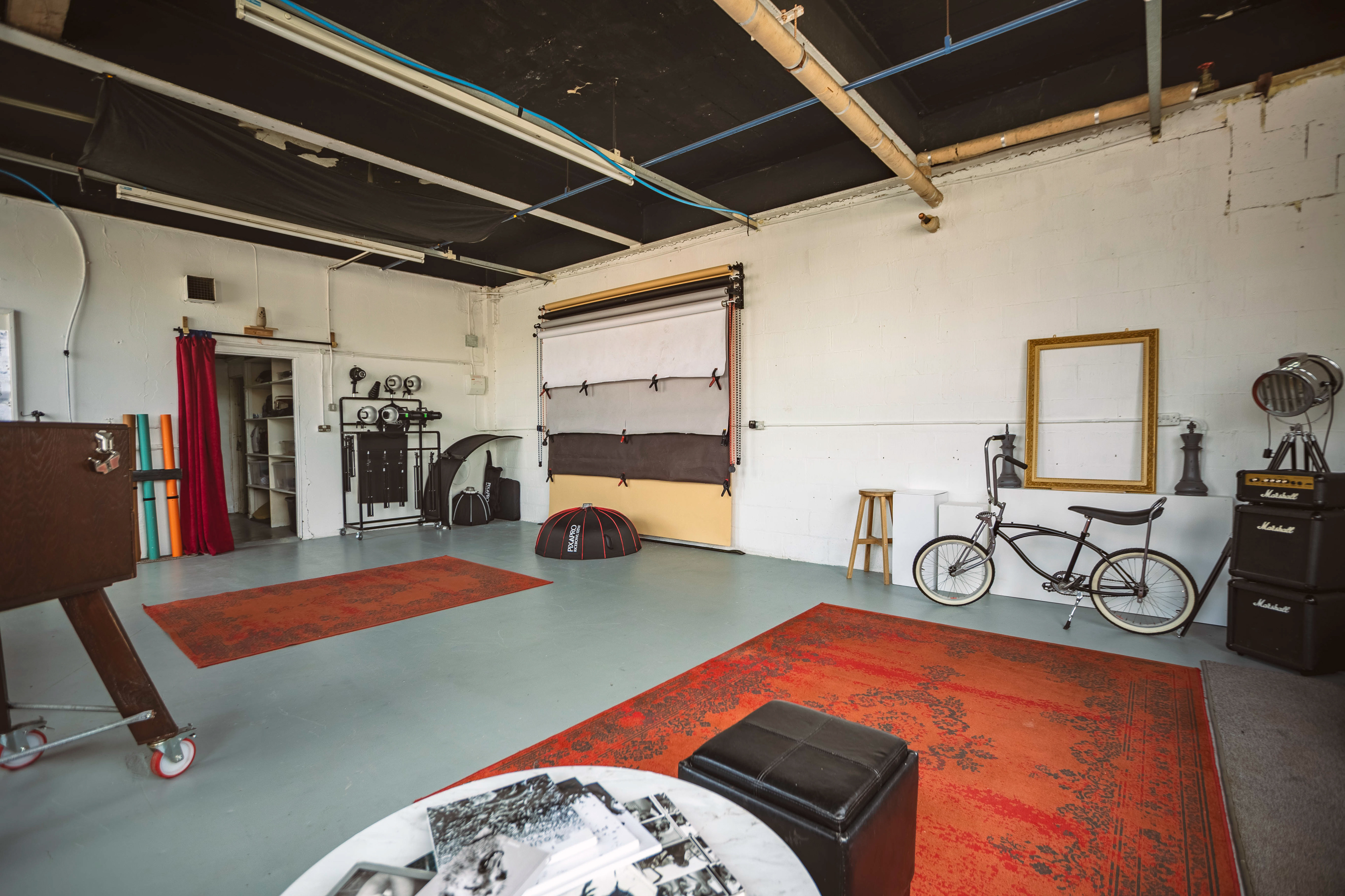 View of a photography studio showing backdrop options on a pulley system