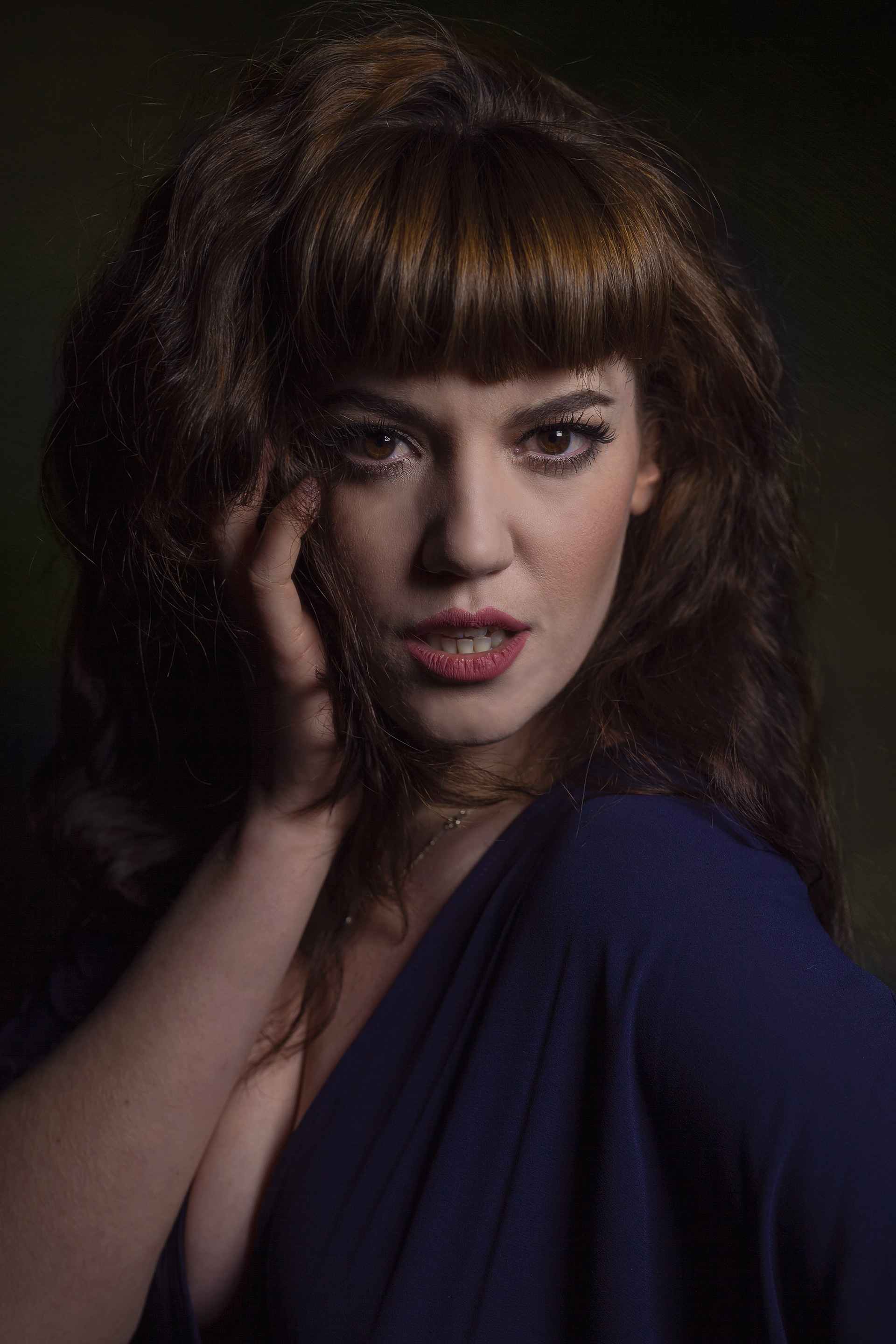 Dark and powerful portrait of a woman staring straight into the camera