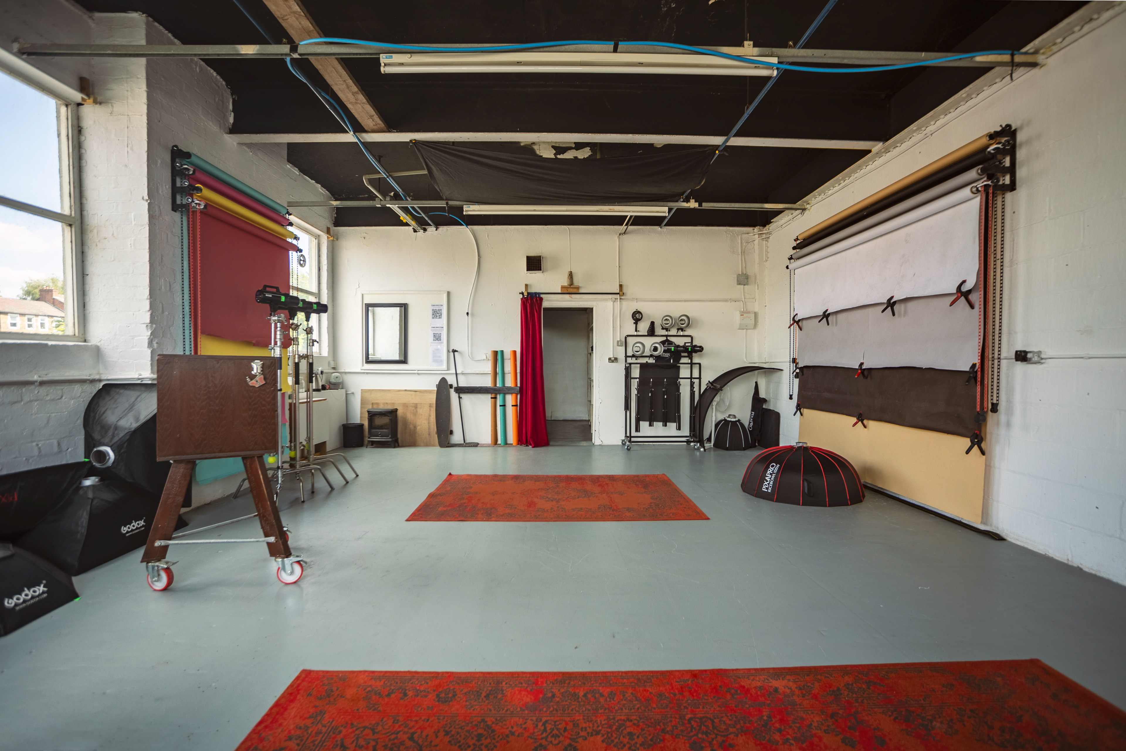 View of a photography studio showing all equipment and backdrops