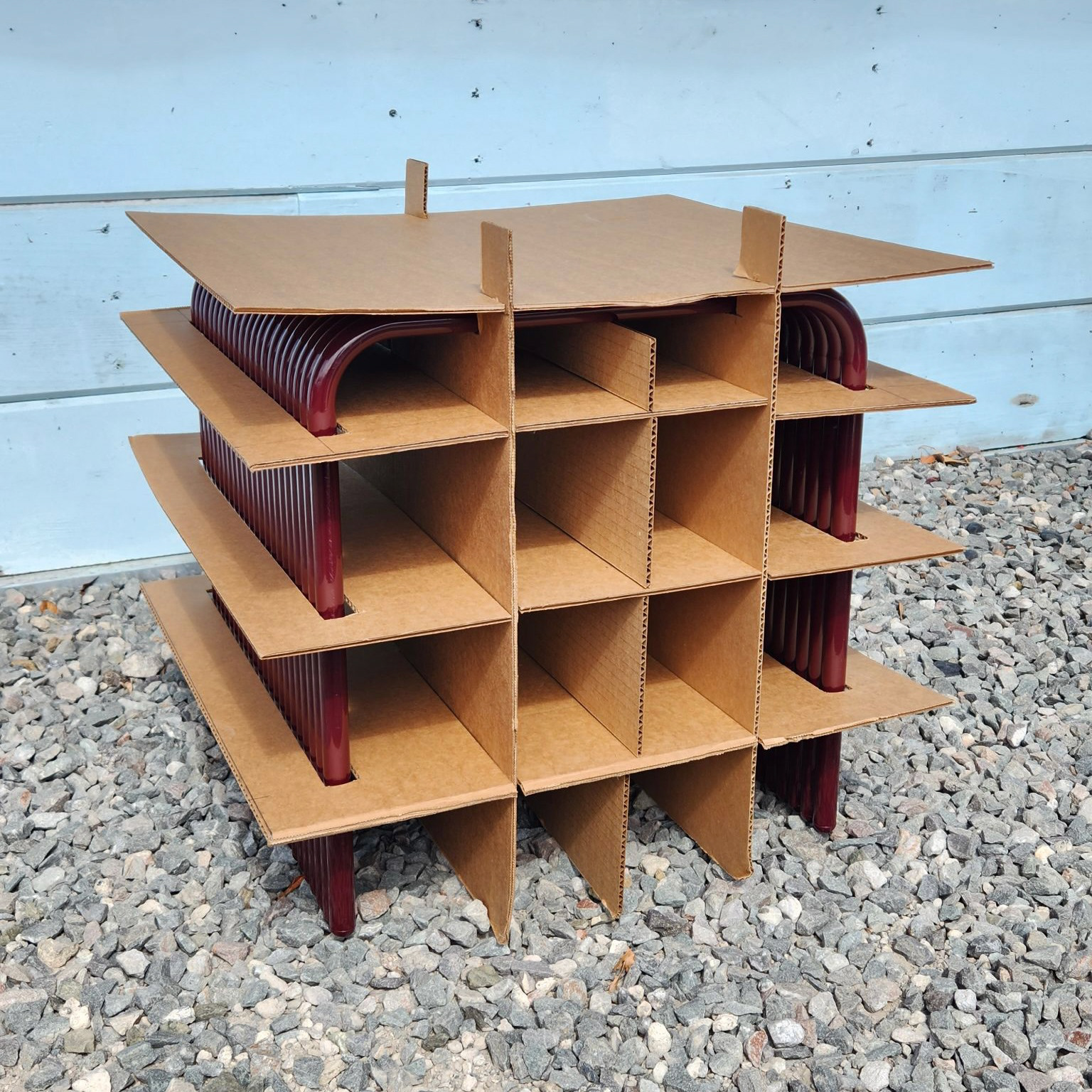 Sliceform panels slot together to fit around the stool without adhesives.
