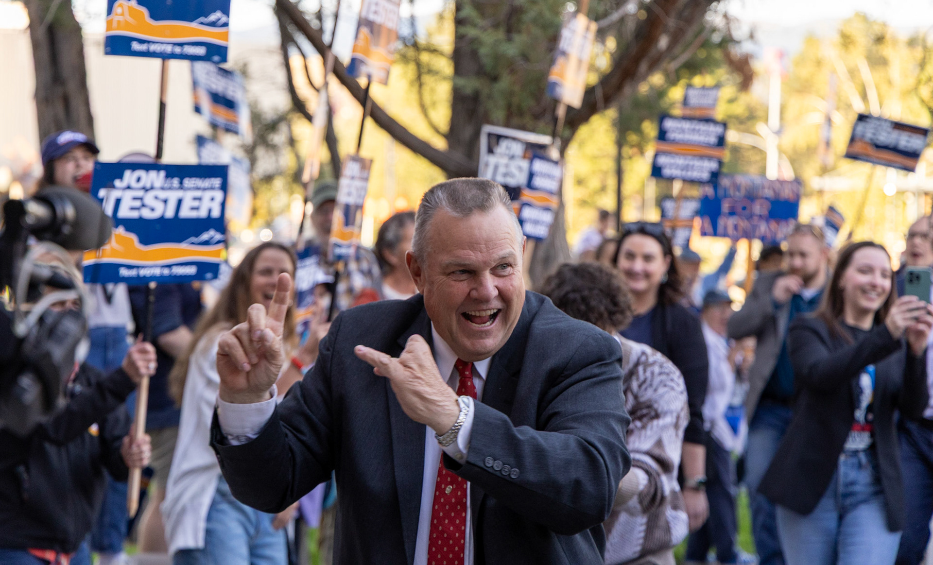 Incumbent Montana Senator John Tester (D) makes his way through a tunnel of supporters into the PARTV building on the University of Montana Campus in Missoula MT for his televised debate with Tim Sheehy (R) on Sep. 30, 2024.