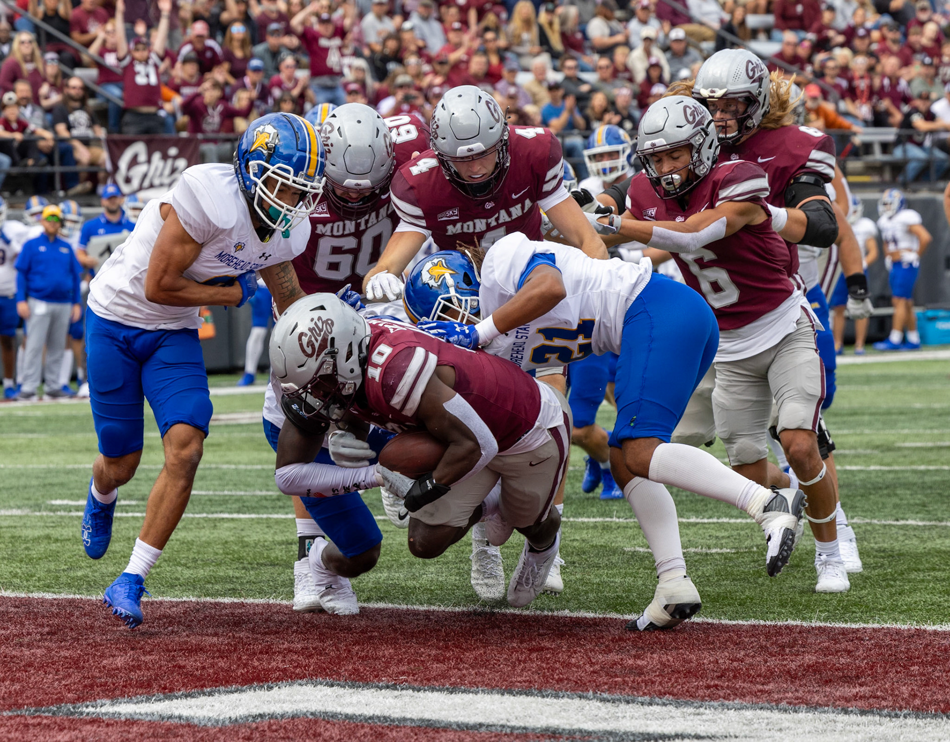Eli Gillman, 10, dives for a touchdown as his fellow Griz and players from the opposing team Morehead State pile around him in Washington-Grizzly Stadium in Missoula MT, on Sep. 14, 2024.