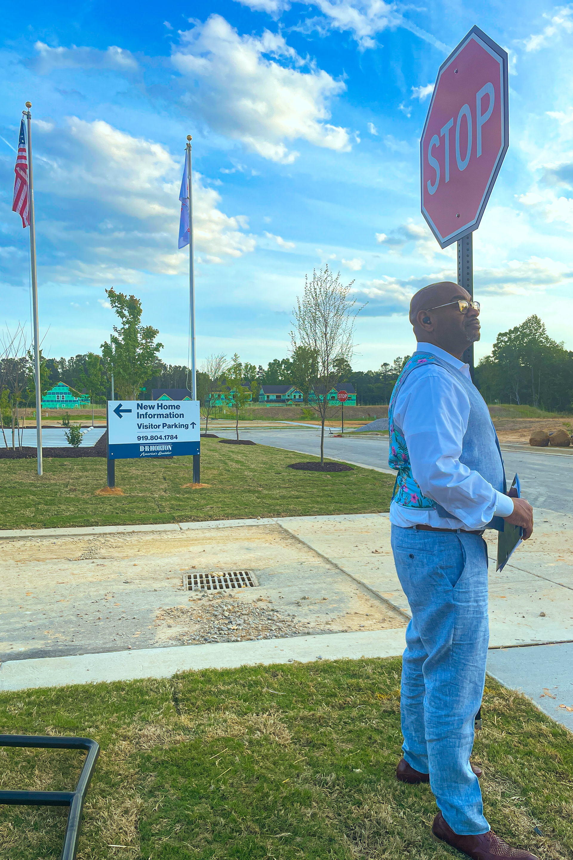 Thinking about the layout of the new homes, Shawn Mclean stands near the visitor parking area on an unrevealed street in Knightdale, NC on April 24, 2023. During a new build, street names are the last thing to be added in the new development. (Photo by Jamesha Robinson)