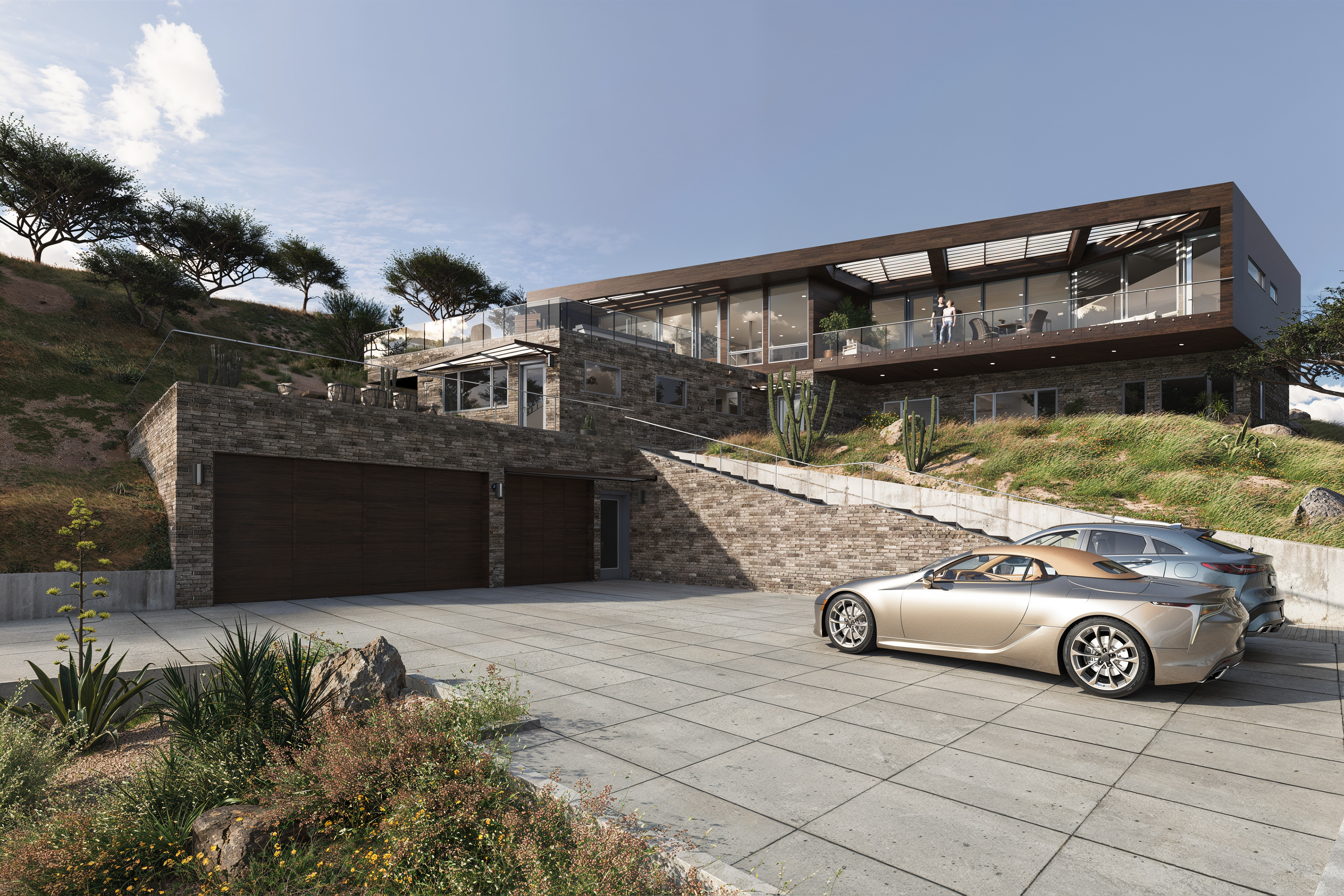 Large modern house built into the hillside with desert plantings and sports cars
