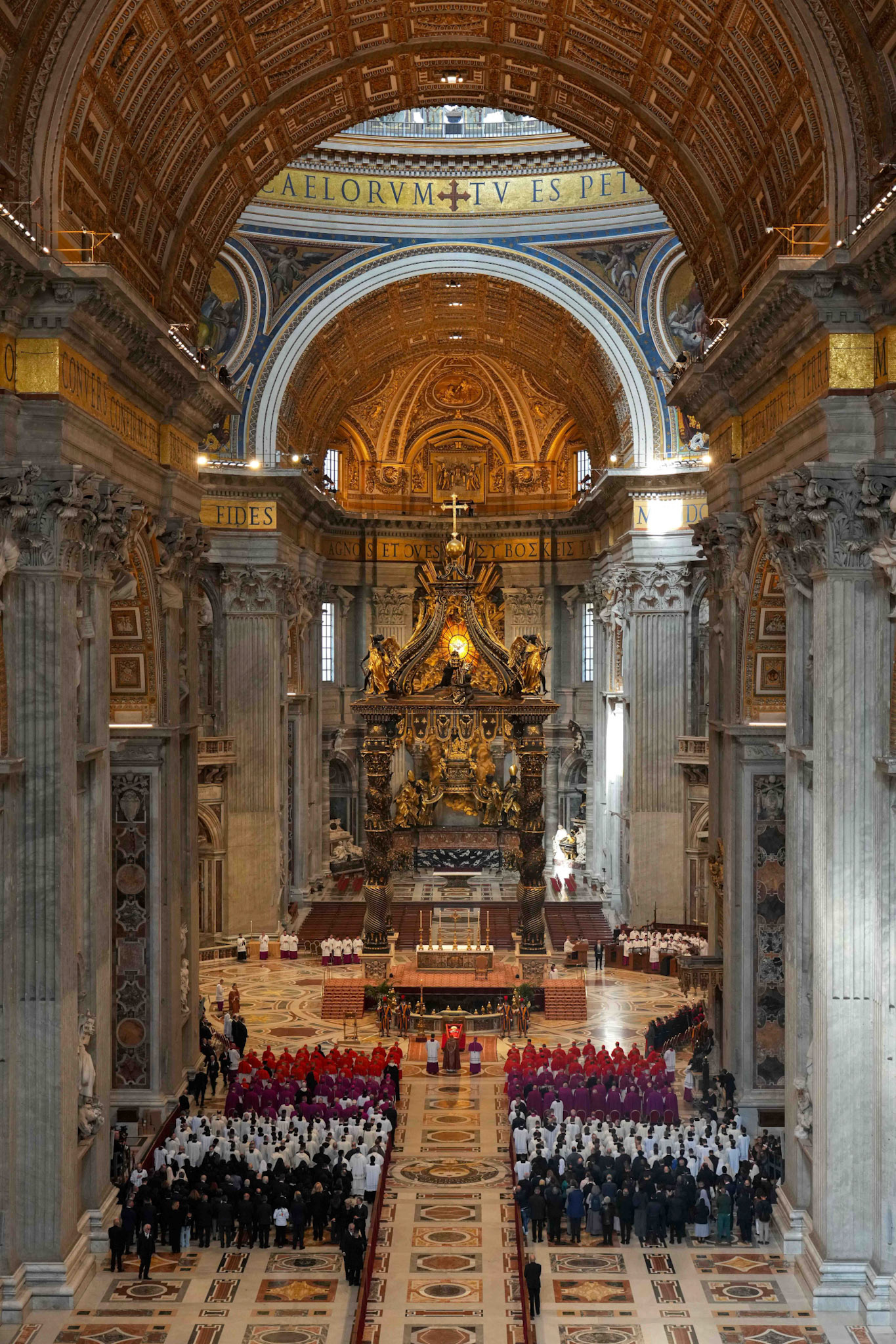 Cardinals and others stand in prayer before the body of Pope Francis in St. Peter's Basilica at the Vatican April 23, 2025. The pope, in an open casket, will lie for public viewing and prayer for three days before his funeral Mass April 26, 2025. (CNS photo/Lola Gomez)