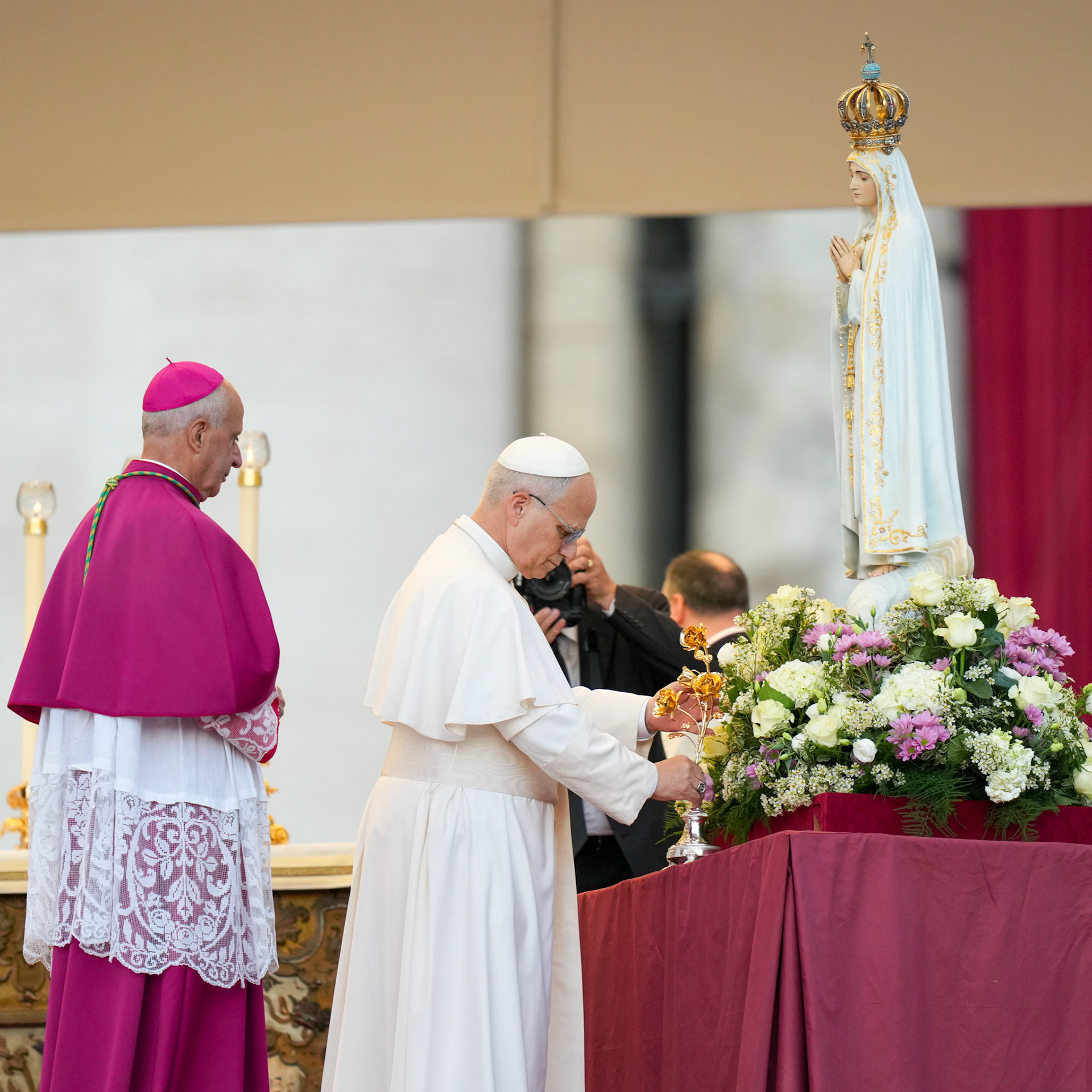 Pope Leo XIV places a gold rose in a vase at the foot of the original statue of Our Lady of Fatima in St. Peter's Square at the Vatican Oct. 11, 2025, before a prayer vigil and the recitation of the rosary for peace. The statue was brought from Portugal to Rome for the Jubilee of Marian Spirituality. (CNS photo/Lola Gomez)