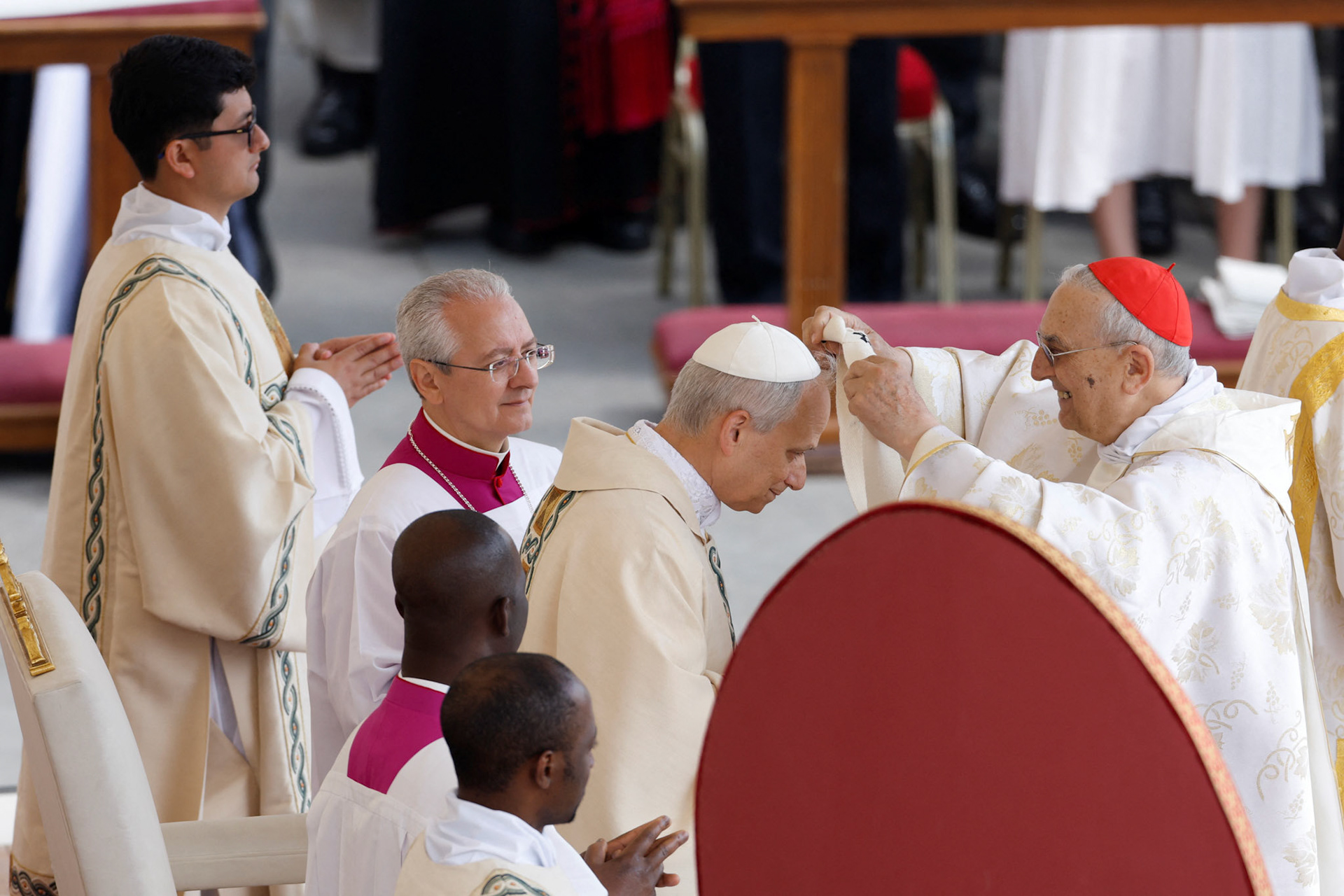 A cardinal places the pallium on Pope Leo XIV, formerly Cardinal Robert Francis Prevost, as the pontiff celebrates his inauguration Mass at the Vatican May 18, 2025. He is the first American pope in history. (OSV News photo/Remo Casilli, Reuters)