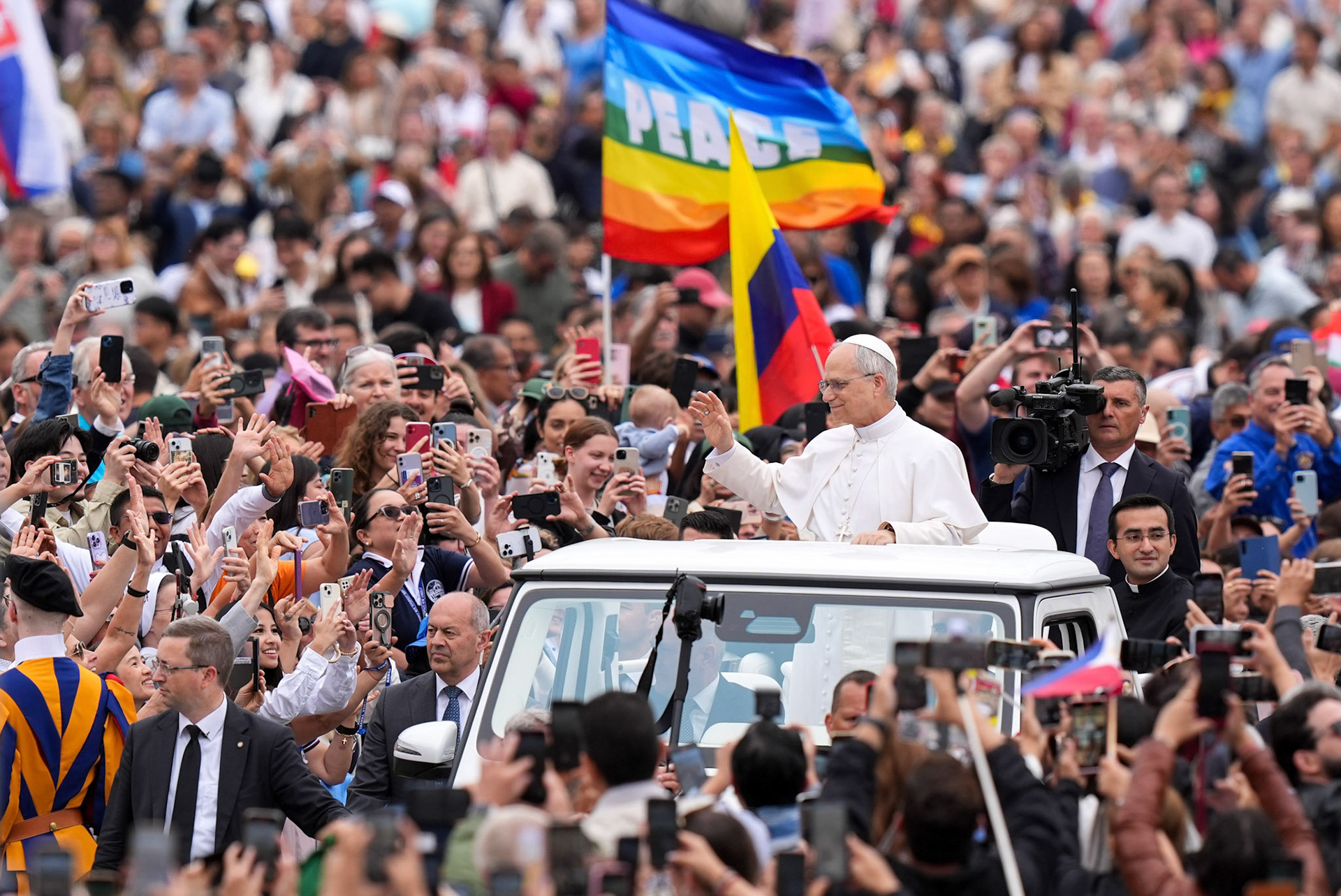 Pope Leo XIV greets people as he arrives in the popemobile to St. Peter’s Square at the Vatican May 21, 2025, ahead of his first weekly general audience. (CNS photo/Lola Gomez)
