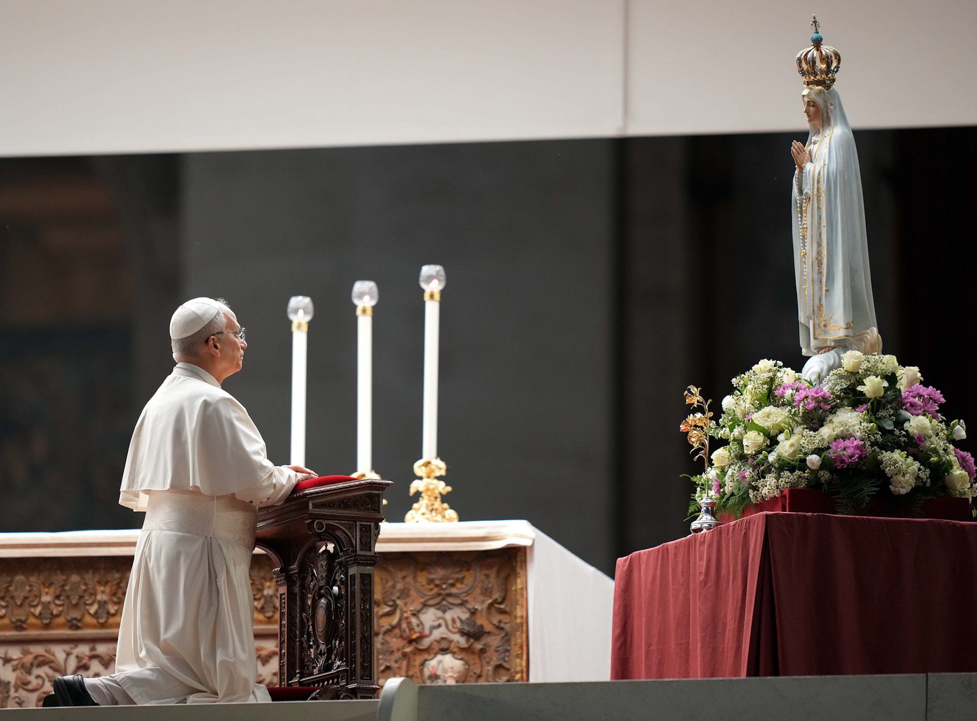 Pope Leo XIV kneels in prayer before the original statue of Our Lady of Fatima during a prayer vigil and recitation of the rosary for peace in St. Peter’s Square at the Vatican Oct. 11, 2025. (CNS photo/Lola Gomez)