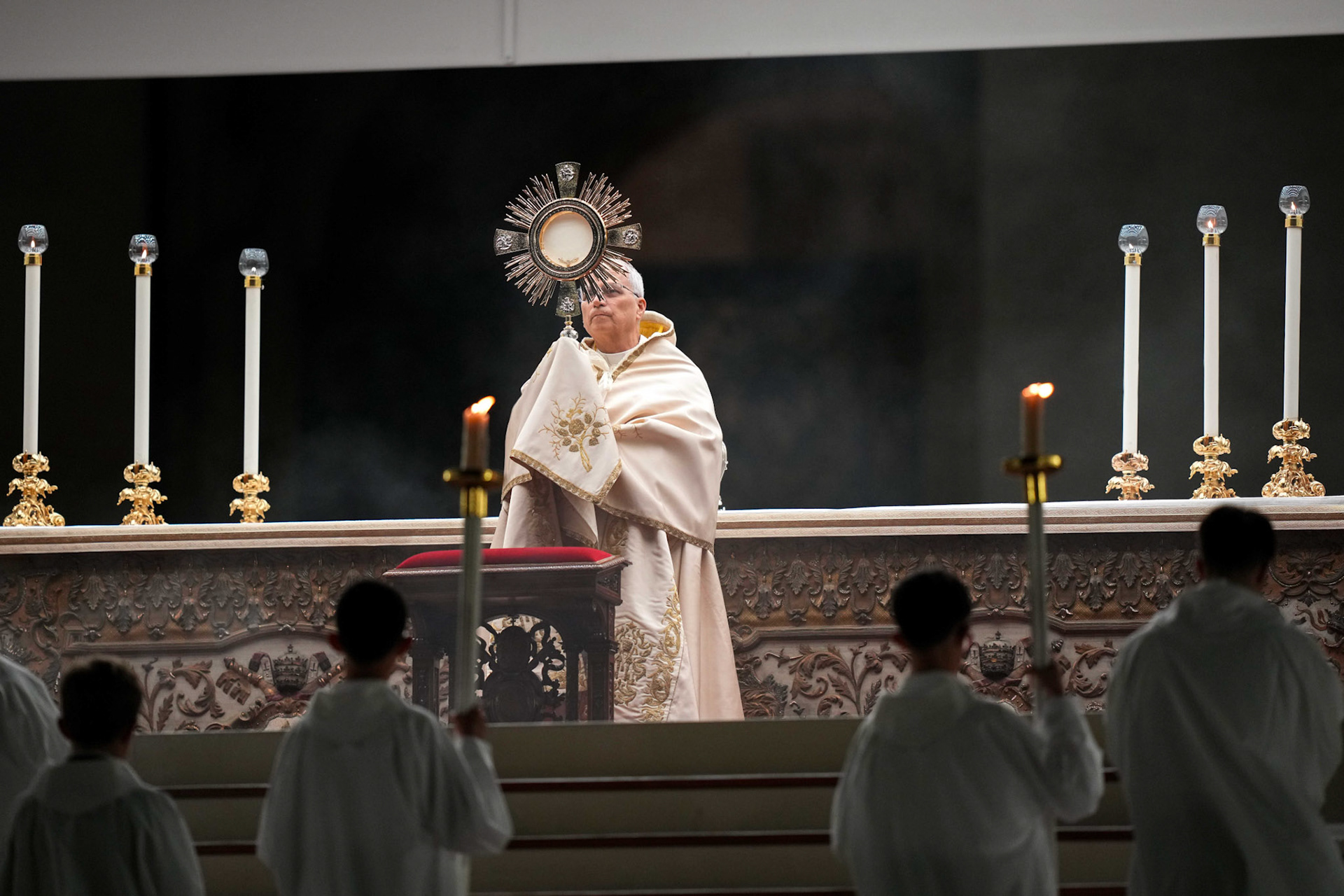 Pope Leo XIV elevates the monstrance containing the Blessed Sacrament for Benediction at the end of a prayer vigil and recitation of the rosary for peace in St. Peter’s Square at the Vatican Oct. 11, 2025. (CNS photo/Lola Gomez)