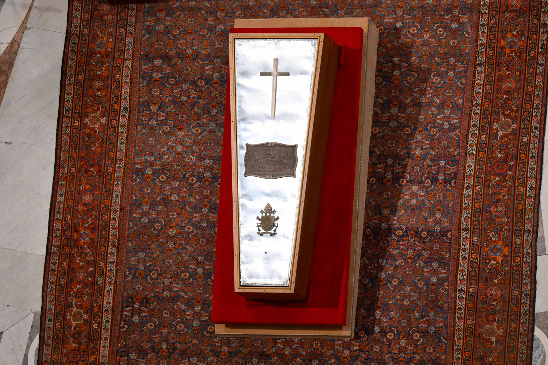The zinc cover of the late Pope Francis' casket is seen April 25, 2025, during a prayer service in St. Peter's Basilica. The cover is decorated with a cross, the coat of arms of Pope Francis and a bronze plate with his name, dates of birth and death. (CNS photo/Vatican Media)