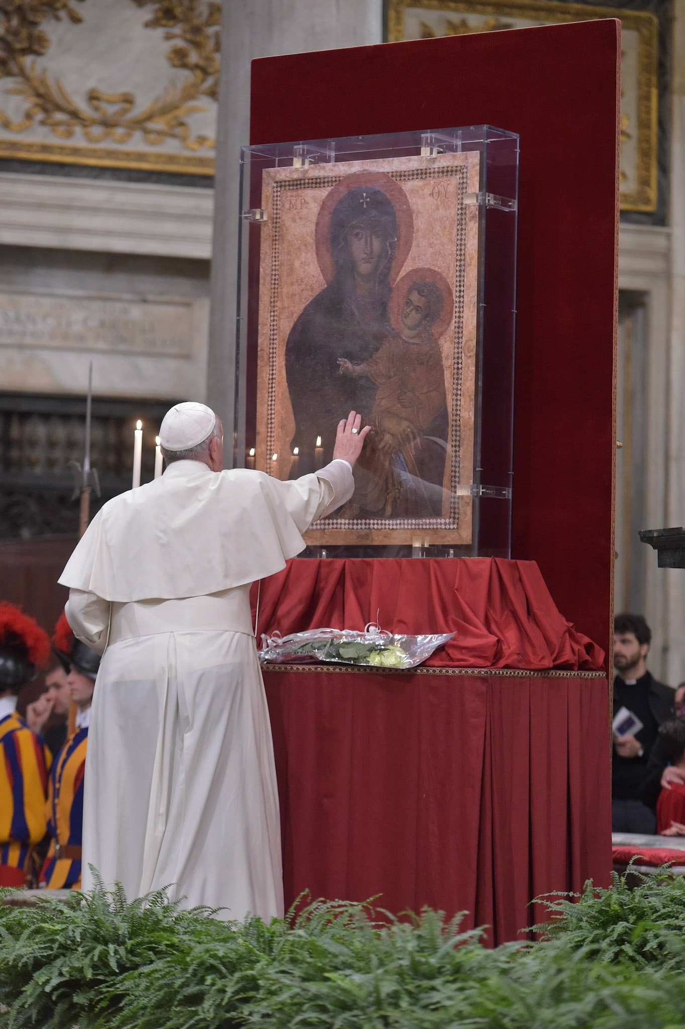 Pope Francis touches the Marian icon, "Salus Populi Romani," (health of the Roman people), during an evening prayer vigil with young people at the Basilica of St. Mary Major in Rome April 8, 2017. Pope Francis died April 21, 2025, at age 88. He will be entombed at the basilica. (CNS photo/L'Osservatore Romano)