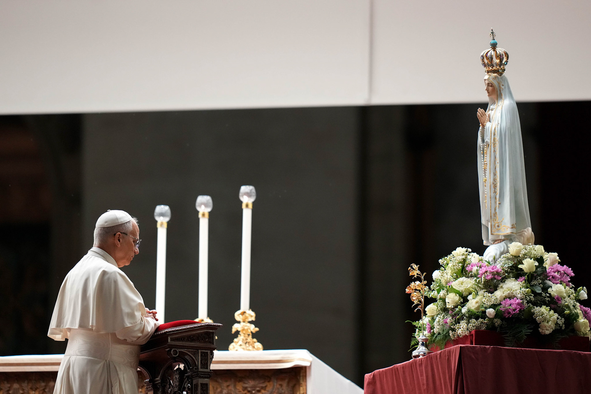 Pope Leo XIV kneels in prayer before the original statue of Our Lady of Fatima during a prayer vigil and recitation of the rosary for peace in St. Peter’s Square at the Vatican Oct. 11, 2025. (CNS photo/Lola Gomez)