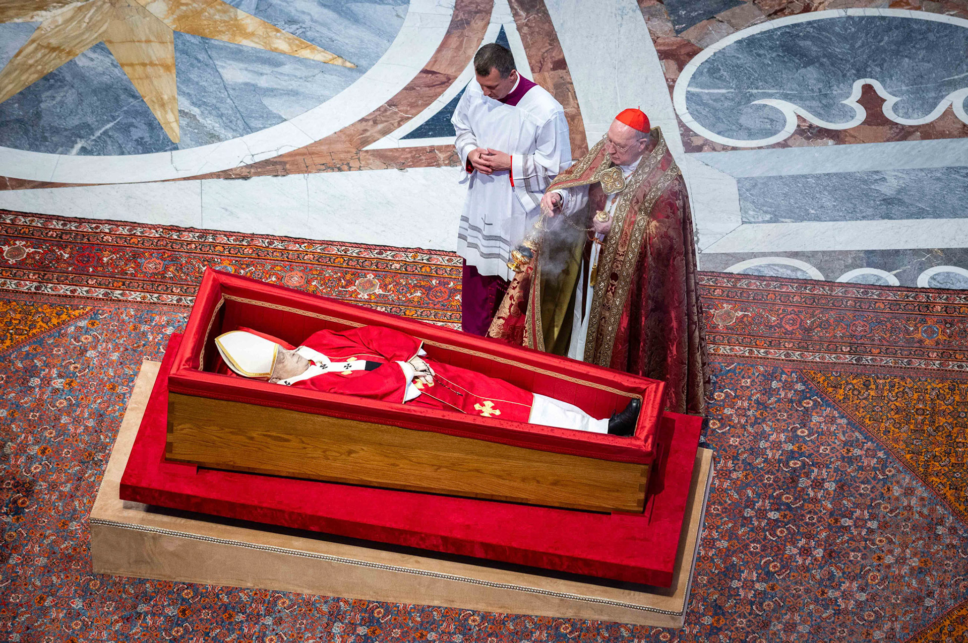 U.S. Cardinal Kevin J. Farrell, camerlengo of the Holy Roman Church, incenses the body of Pope Francis in St. Peter’s Basilica at the Vatican April 23, 2025. The pope, in an open casket, will lie in state for public viewing and prayer for three days ahead of his funeral Mass April 26. (CNS photo/Paolo Galosi, pool)