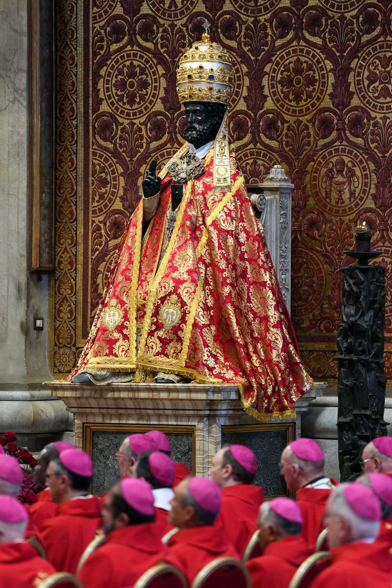 The statue of St. Peter is adorned with papal vestments for the feast of Sts. Peter and Paul as bishops and cardinals attend Mass celebrated by Pope Leo XIV in St. Peter’s Basilica at the Vatican June 29, 2025. (CNS photo/Lola Gomez)