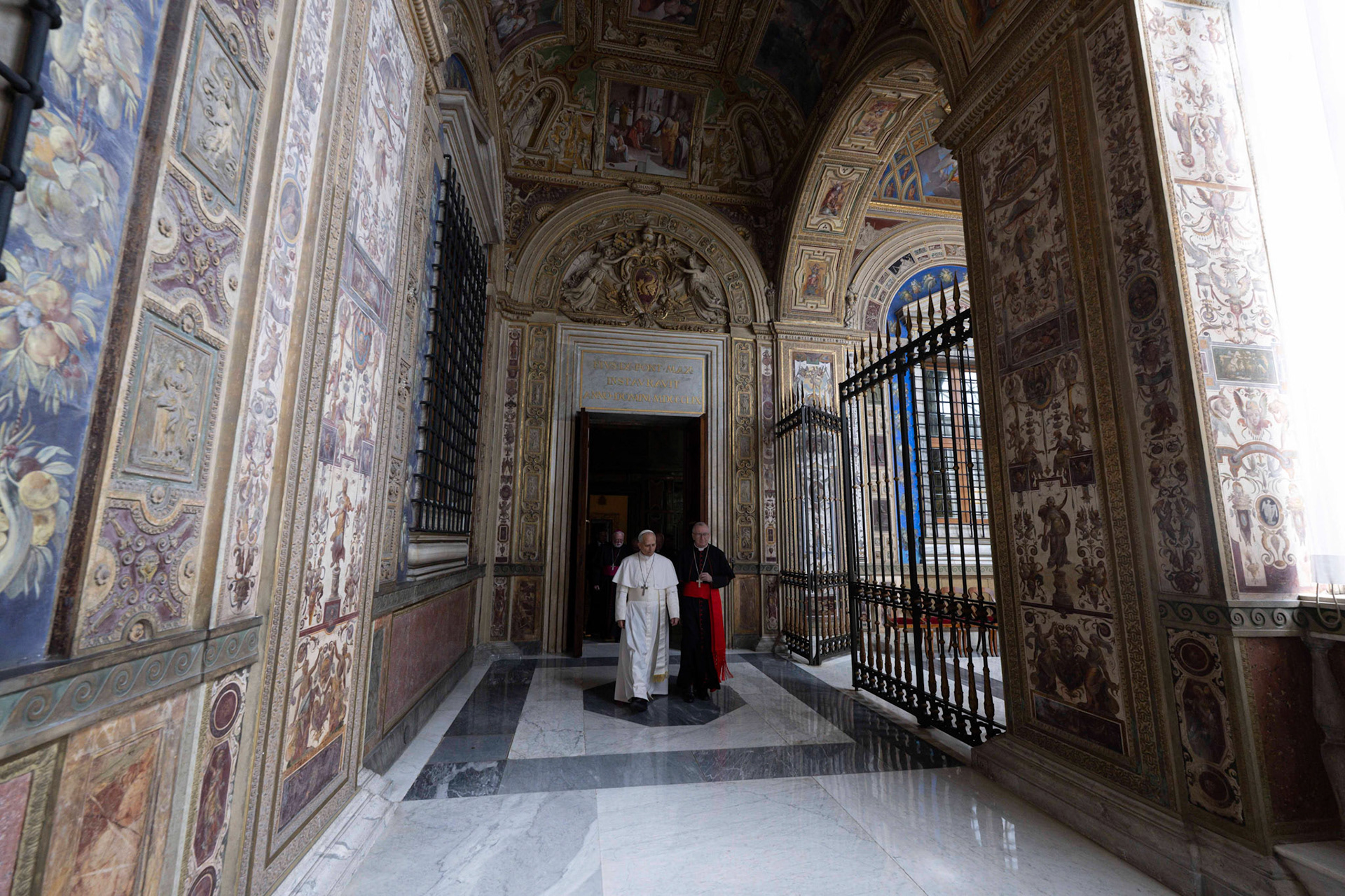 Pope Leo XIV walks with Cardinal Pietro Parolin, Vatican secretary of state, in a frescoed corridor of the Apostolic Palace after visiting the papal apartment there May 11, 2025. The Vatican has not said whether the new pope intends to live in the apartment. (CNS photo/Vatican Media)