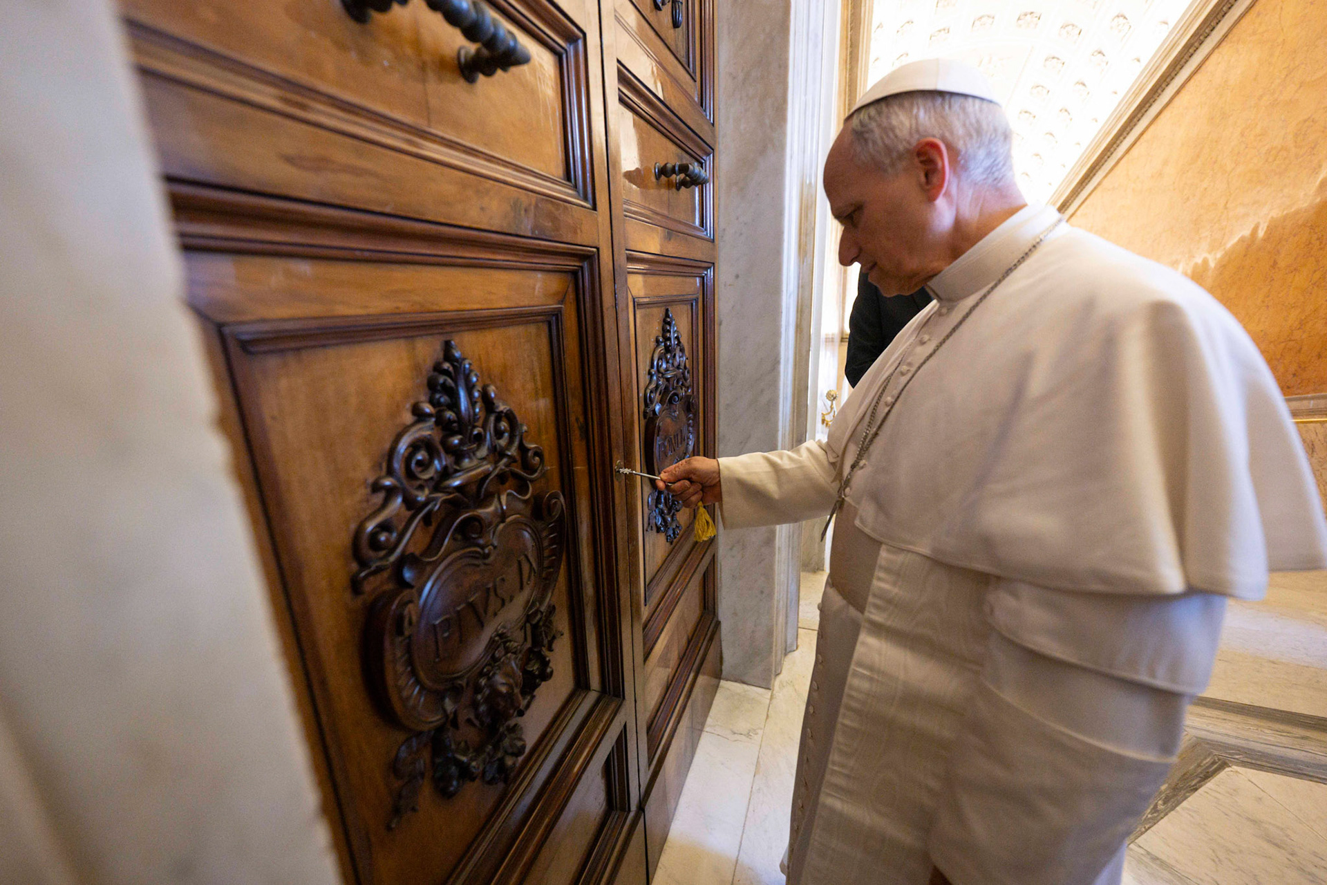 Pope Leo XIV opens the door to the papal apartment in the Apostolic Palace at the Vatican May 11, 2025. The Vatican has not said whether the new pope intends to live there. (CNS photo/Vatican Media)
