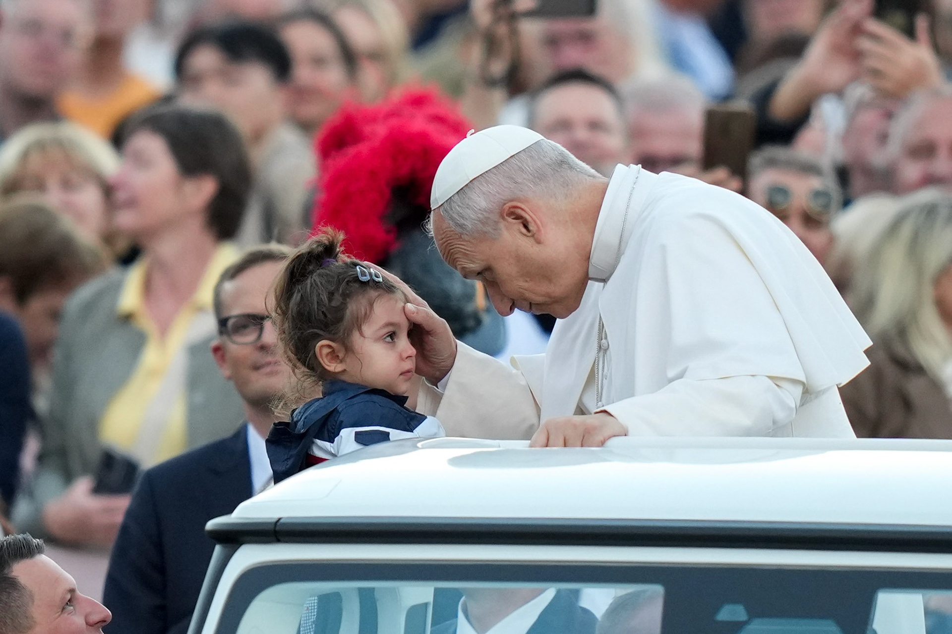Pope Leo XIV greets a child from the popemobile as he rides around St. Peter’s Square at the Vatican before leading a prayer vigil and recitation of the rosary for peace in the presence of the original statue of Our Lady of Fatima Oct. 11, 2025. (CNS photo/Lola Gomez)