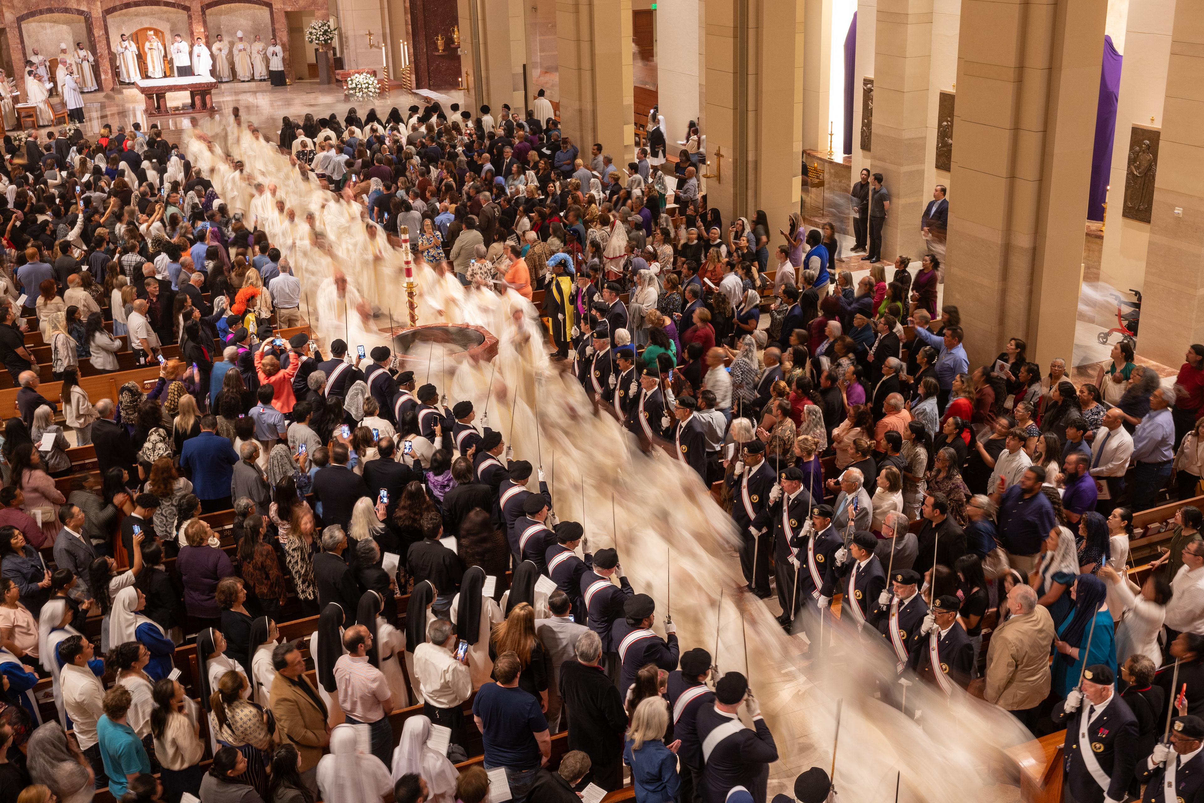Priests process down the aisle of the Co-Cathedral of the Sacred Heart at Chrism Mass in March. (Photo by James Ramos/Herald)