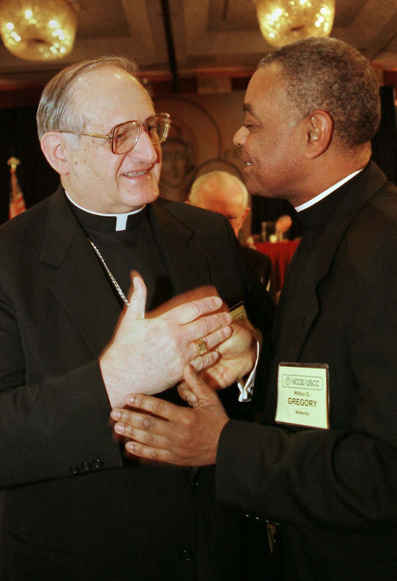 ELECTED BISHOPS -- New NCCB president Bishop Joseph A. Fiorenza (left) and vice president Bishop Wilton D. Gregory greet one another following their election at the U.S. bishops' meeting in Washington Nov. 17. Bishop Fiorenza, of the Galveston-Houston Diocese, is the first head of the bishops' conference to come from the South. Bishop Gregory of Bellville, Ill., is the first black bishop to take the vice-president post. (CNS photo by Nancy Wiechec) (Nov. 17, 1998) See BISHOPS-ELECT Nov. 17, 1998.