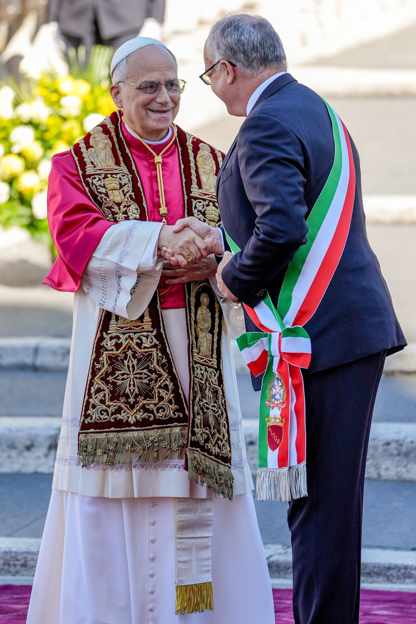 Pope Leo XIV and Rome Mayor Roberto Gualtieri shake hands after exchanging remarks in Aracoeli Square in Rome May 25, 2025. (CNS photo/Lola Gomez)