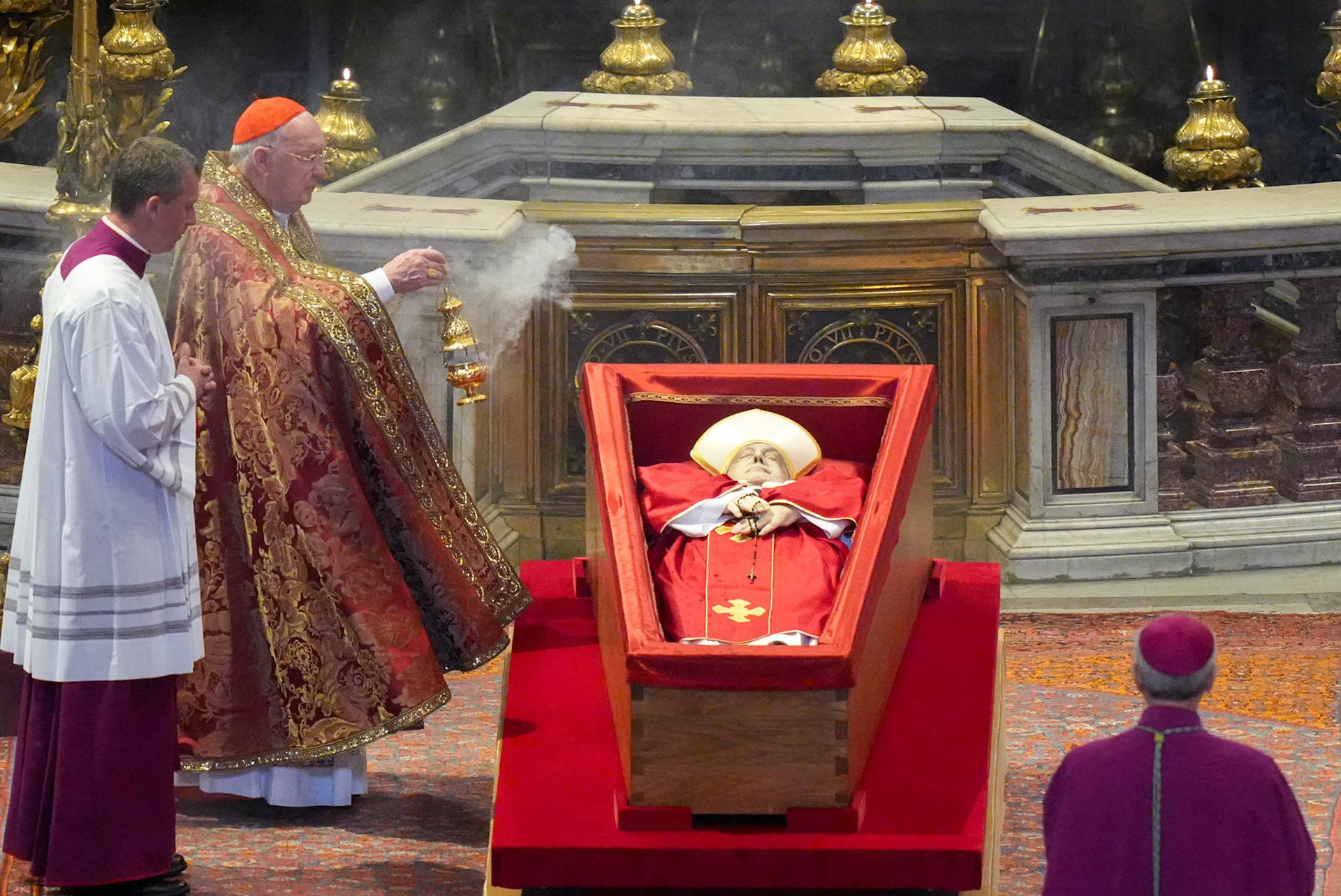 U.S. Cardinal Kevin J. Farrell, camerlengo of the Holy Roman Church, incenses the body of Pope Francis in St. Peter’s Basilica at the Vatican April 23, 2025. The pope, in an open casket, will lie in state for public viewing and prayer for three days ahead of his funeral Mass April 26. (CNS photo/Lola Gomez)