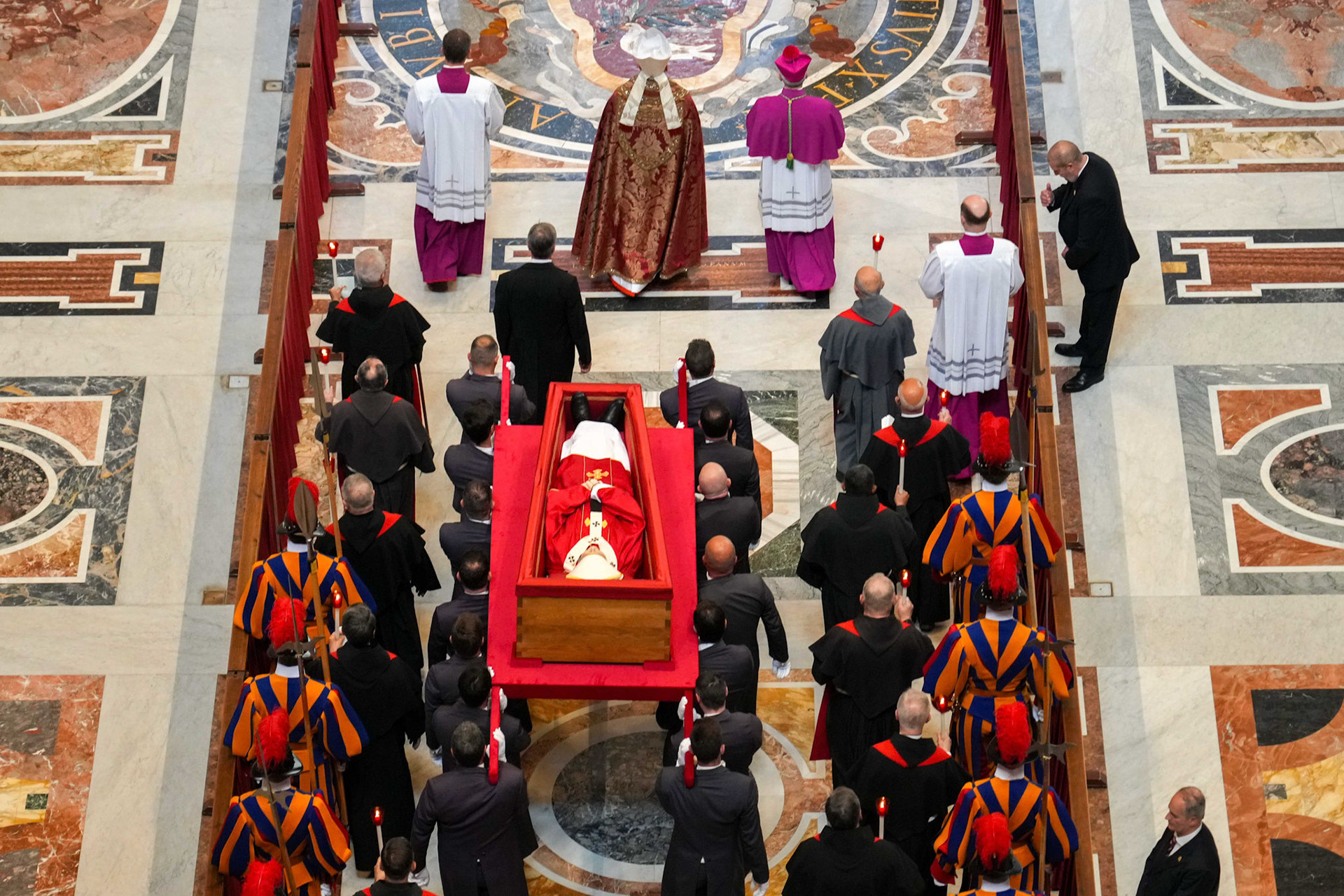 Pallbearers carry the body of Pope Francis in an open casket during the procession into St. Peter’s Basilica at the Vatican April 23, 2025. The pope will lie in the basilica for public viewing and prayer for three days before his funeral Mass April 26, 2025. (CNS photo/Lola Gomez)