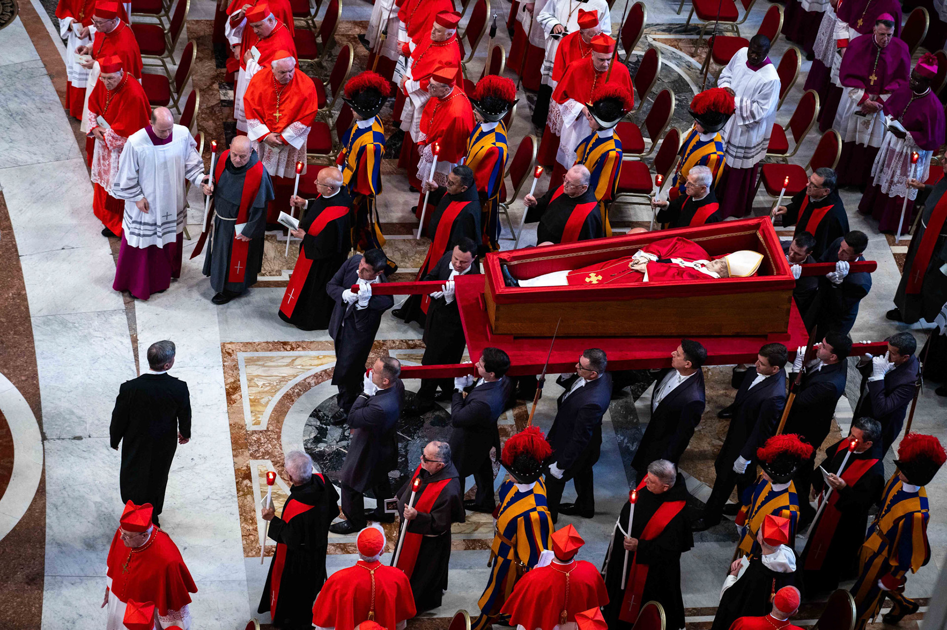 Pallbearers carry the body of Pope Francis in an open casket during the procession into St. Peter’s Basilica at the Vatican April 23, 2025. The pope will lie in the basilica for public viewing and prayer for three days before his funeral Mass April 26, 2025. (CNS photo/Paolo Galosi, pool)