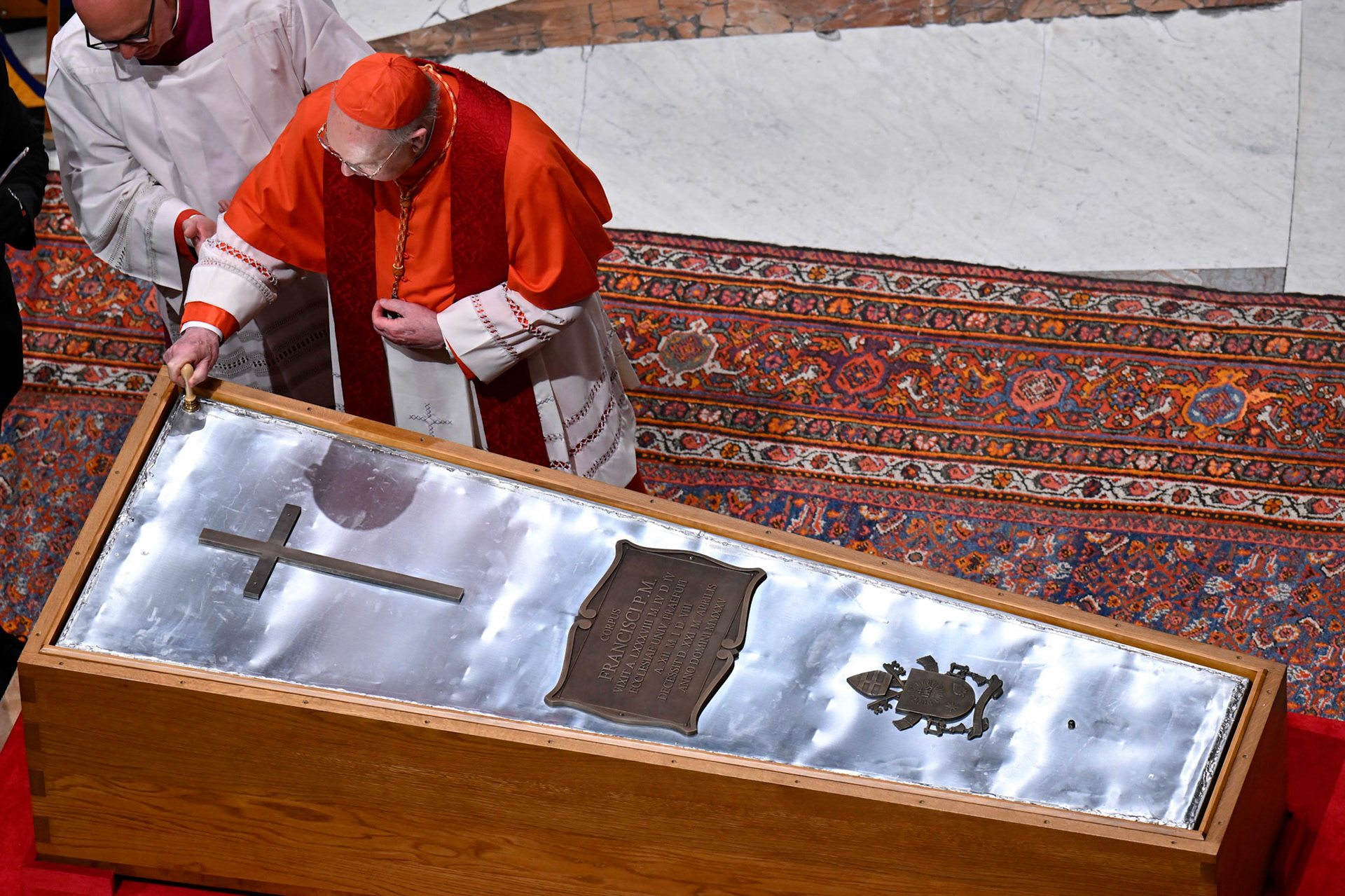 U.S. Cardinal Kevin J. Farrell, chamberlain of the Holy Roman Church, places a seal on the zinc cover of Pope Francis' casket as it is sealed during a prayer service in St. Peter's Basilica at the Vatican April 25, 2025. (CNS photo/Vatican Media)