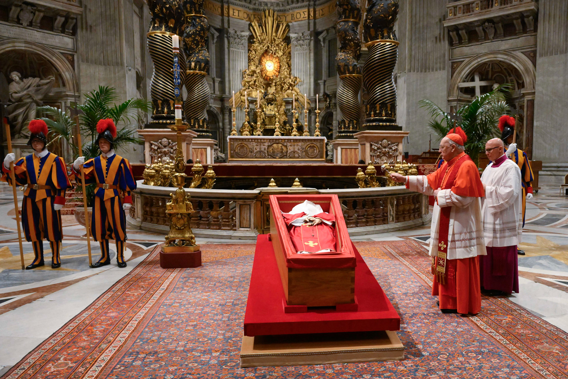 U.S. Cardinal Kevin J. Farrell, chamberlain of the Holy Roman Church, sprinkles Pope Francis' body with holy water before his casket is sealed during a prayer service in St. Peter's Basilica at the Vatican April 25, 2025. (CNS photo/Vatican Media)