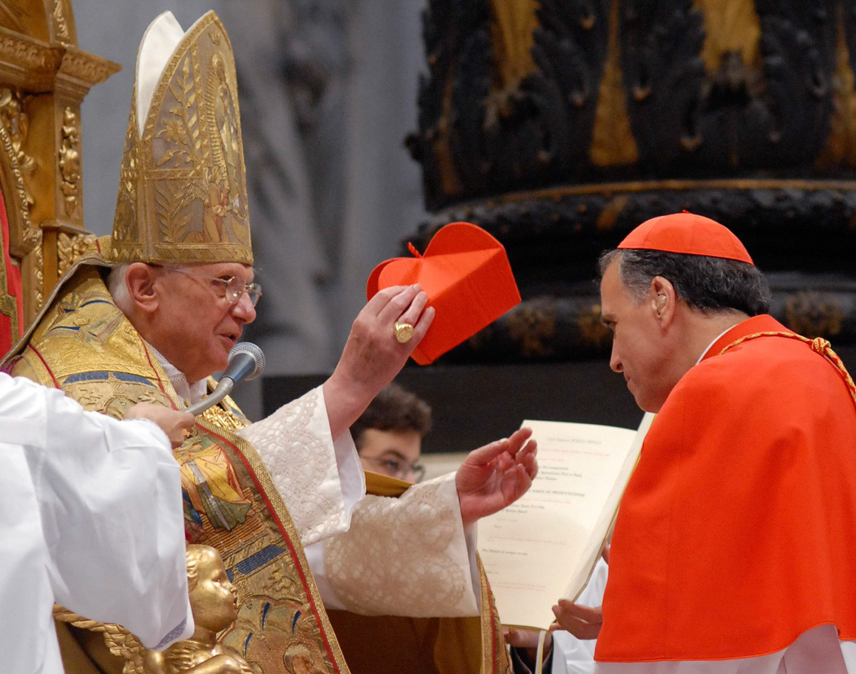 U.S. Cardinal Daniel N. DiNardo of Galveston-Houston receives the red biretta from Pope Benedict XVI during the consistory in St. Peter's Basilica at the Vatican Nov. 24. The pope elevated 23 churchmen from around the world to the rank of cardinal. (CNS photo/L'Osservatore Romano via Reuters) (Nov. 24, 2007)