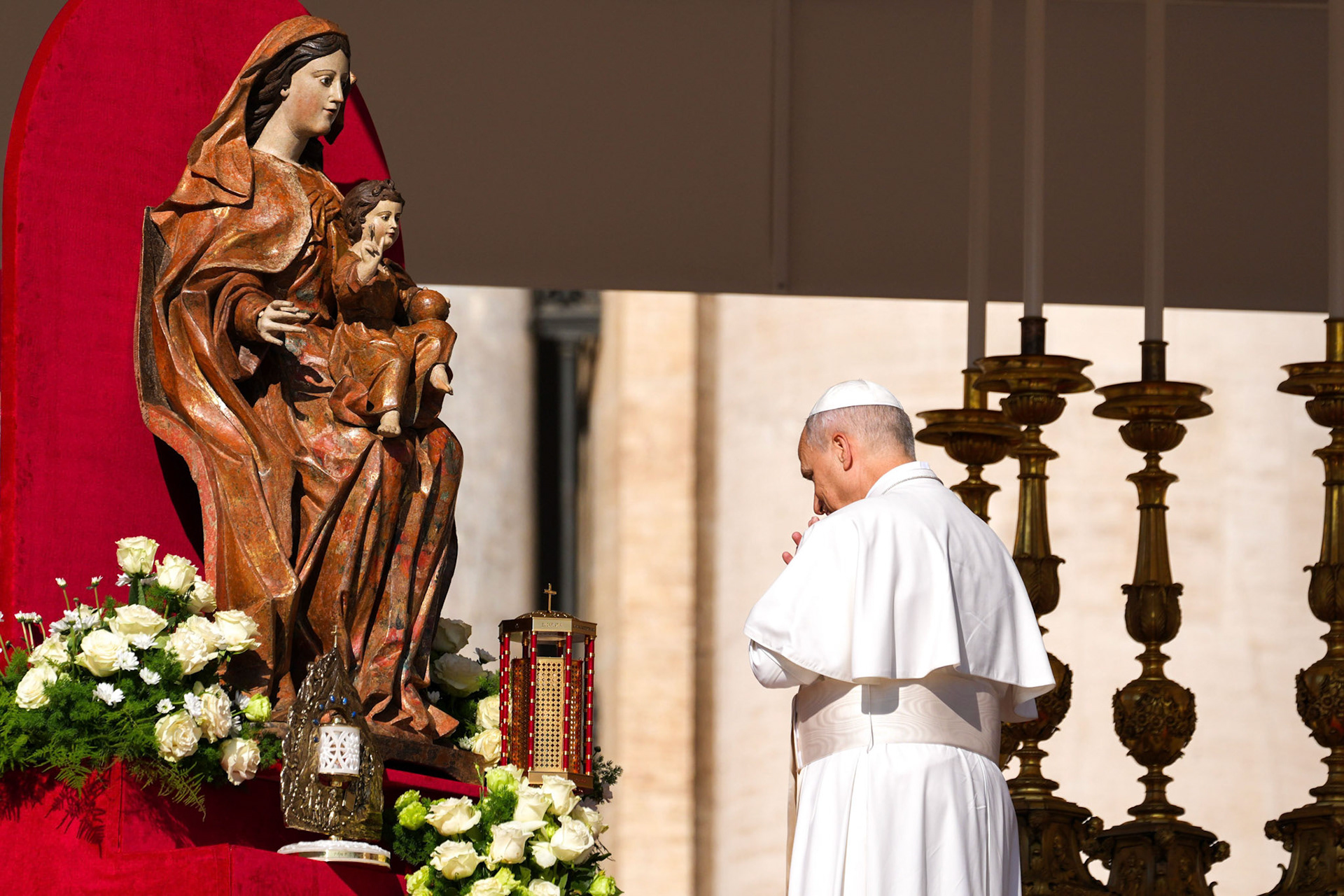 Pope Leo XIV prays before a statue of Mary and the Child Jesus behind the relics of Sts. Carlo Acutis and Pier Giorgio Frassati during the Mass for their canonization in St. Peter’s Square at the Vatican Sept. 7, 2025. (CNS photo/Lola Gomez)