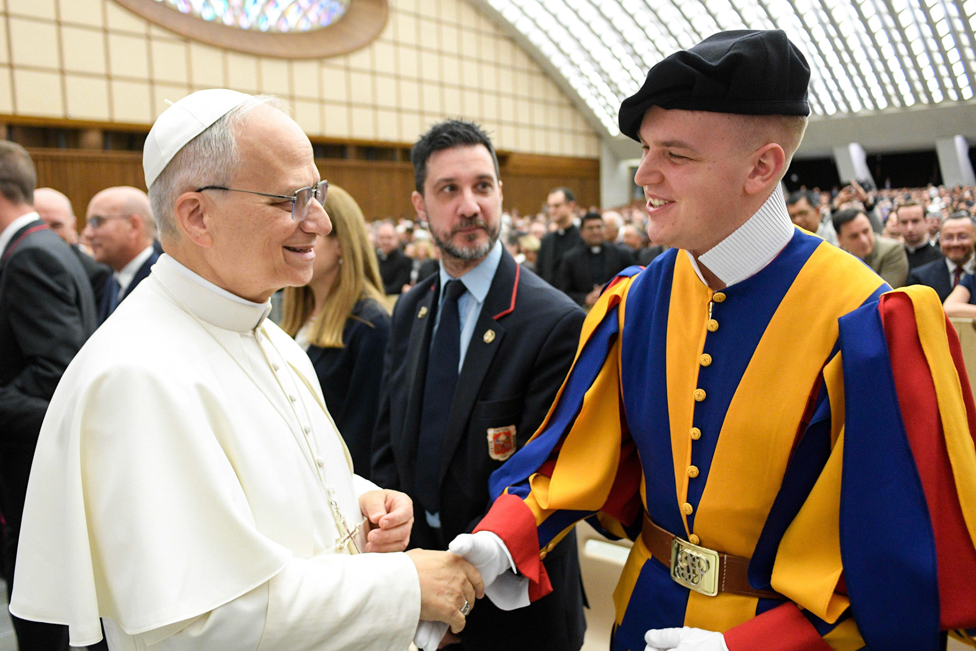 Pope Leo XIV greets a member of the Swiss Guard during a meeting with officials and employees of the Roman Curia, Vatican City State and the Diocese of Rome in the Paul VI Audience Hall at the Vatican May 24, 2025. (CNS photo/Vatican Media)
