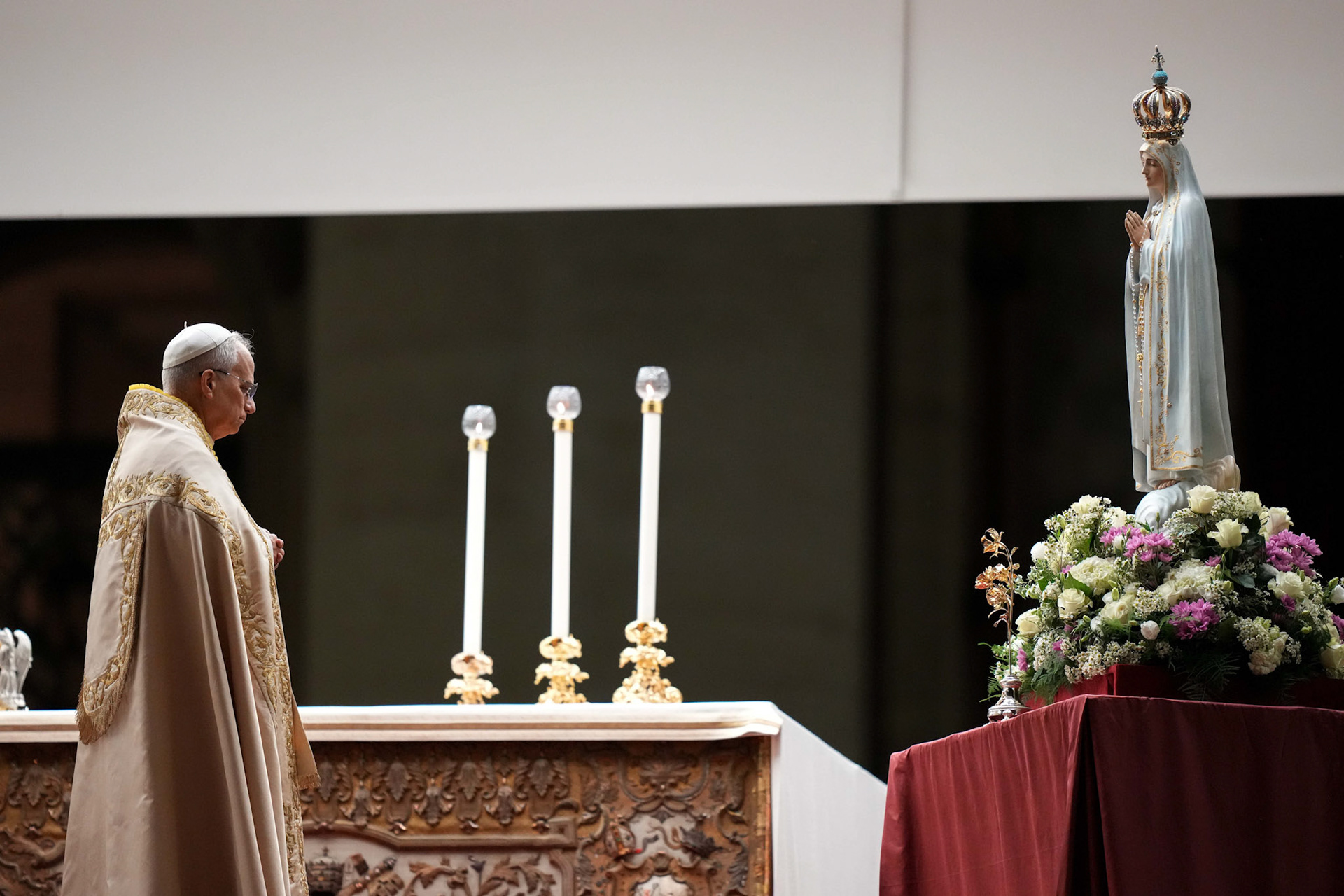 Pope Leo XIV stands in silent prayer before the original statue of Our Lady of Fatima during a prayer vigil and recitation of the rosary for peace in St. Peter’s Square at the Vatican Oct. 11, 2025. (CNS photo/Lola Gomez)
