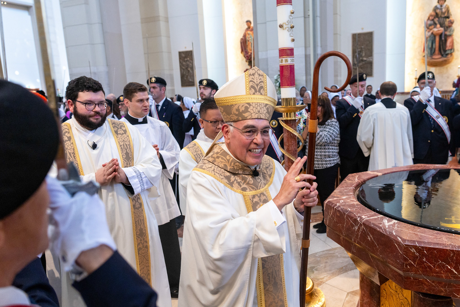Archbishop Joe S. Vásquez smiles as he processes out of the Co-Cathedral of the Sacred Heart at the conclusion of his Installation Mass in March. (Photo by James Ramos/Herald)