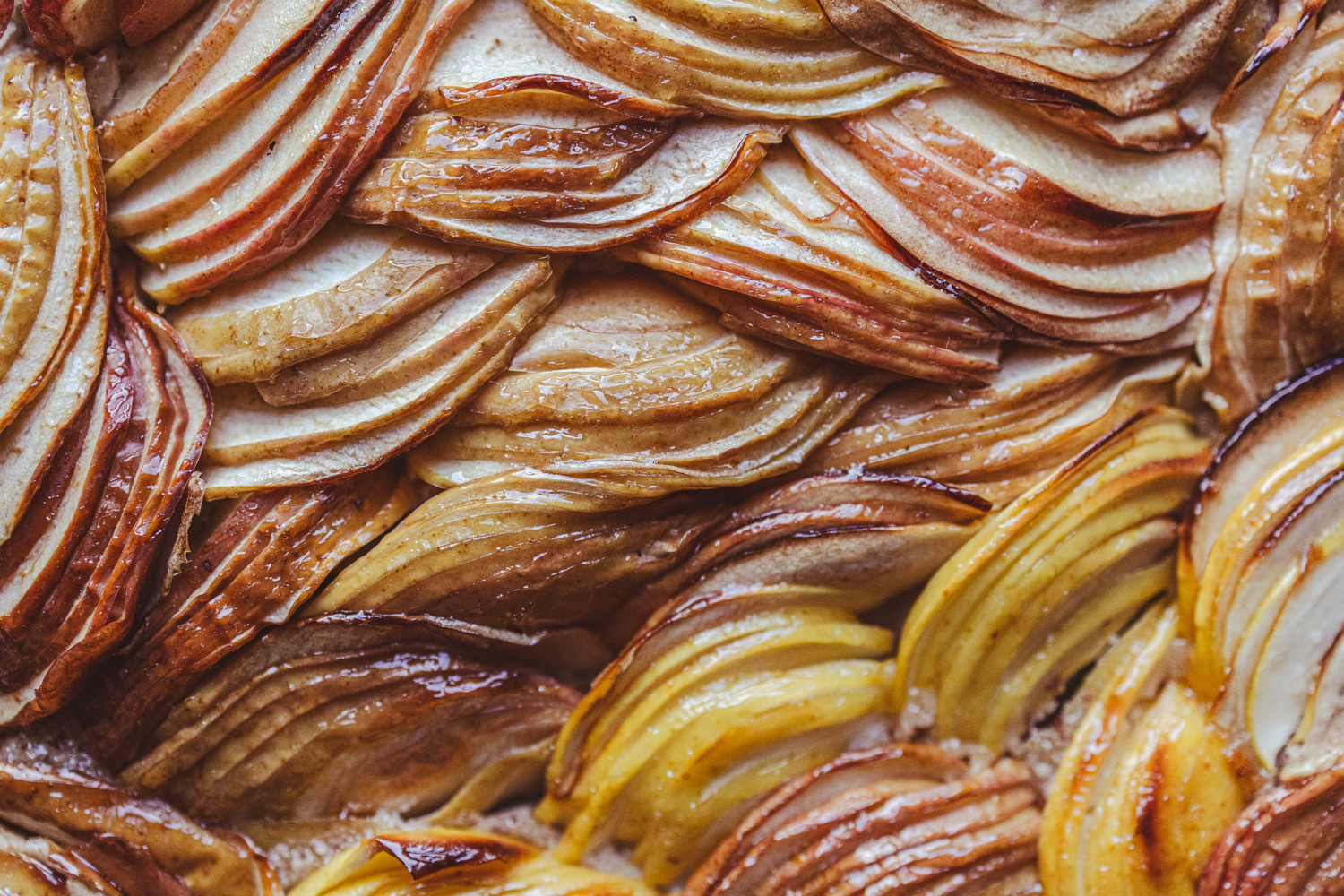 Close up of cooked sliced apples topping apple tart.