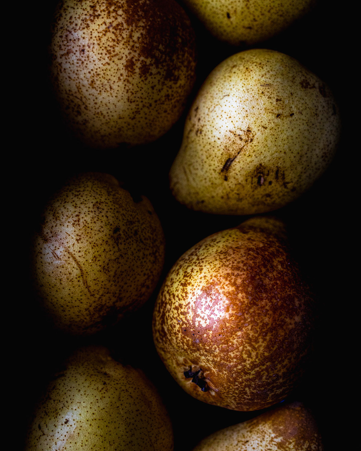 Pears huddled in dark, close up