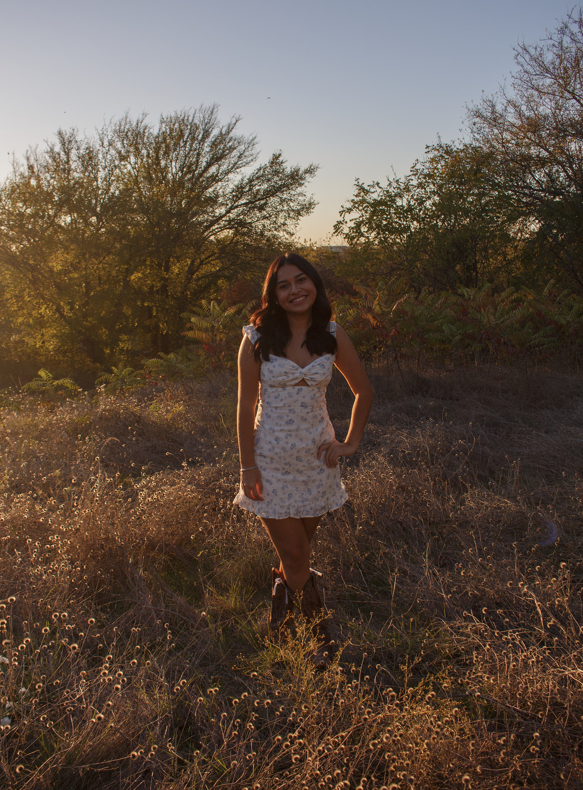 With her hand on her hip, Gabriela Alaniz stands in a field of dying flora at Arbor Hills Nature Preserve on Nov. 10, 2024. Photo/ Natalie VanDerWal