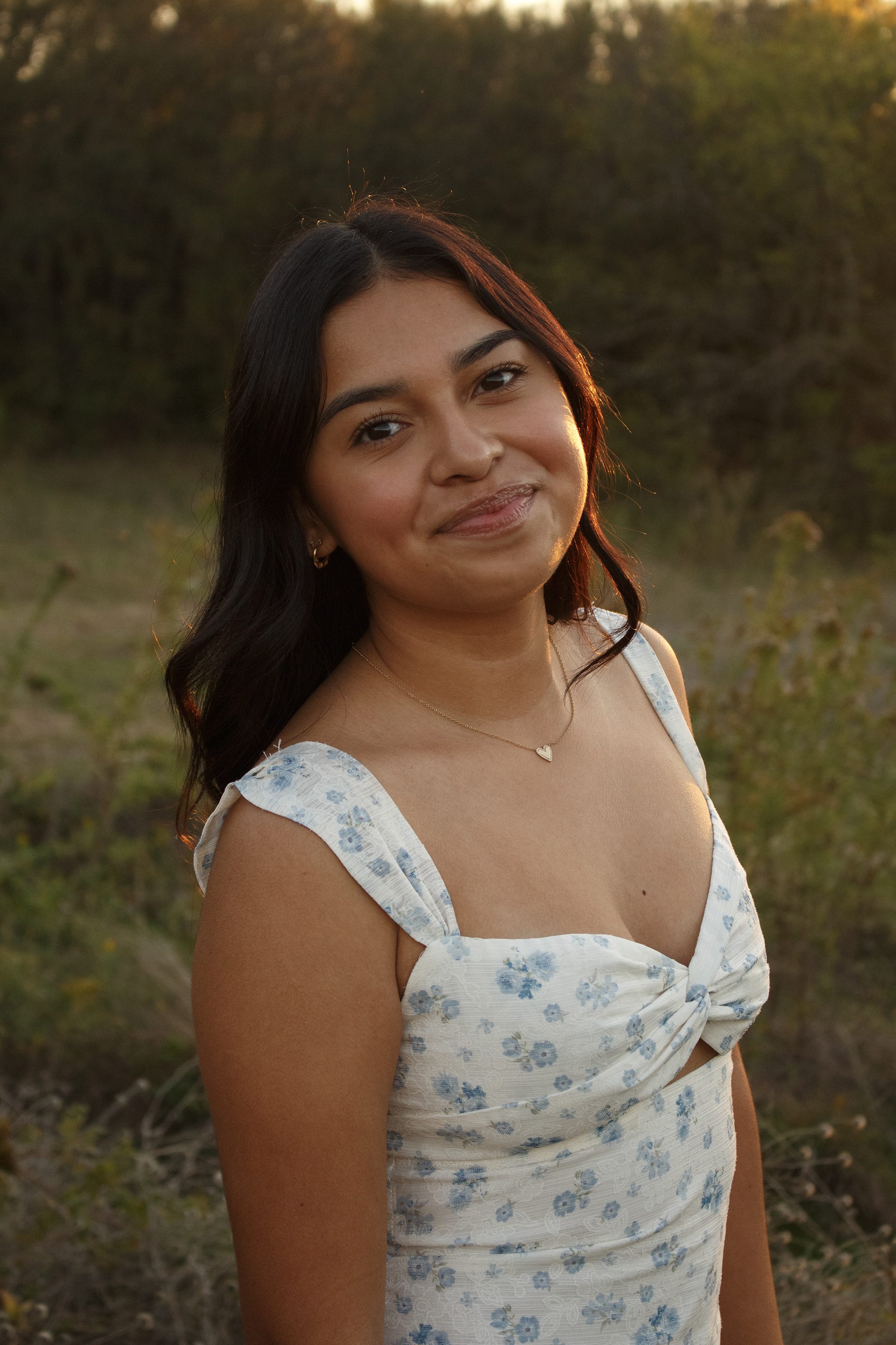 Gabriela Alaniz holds back laughter as she poses for a portrait photo at Arbor Hills Nature Preserve on Nov. 10, 2024. Alaniz was struggling to take the moment seriously, since she is a naturally giggly person. Photo/ Natalie VanDerWal