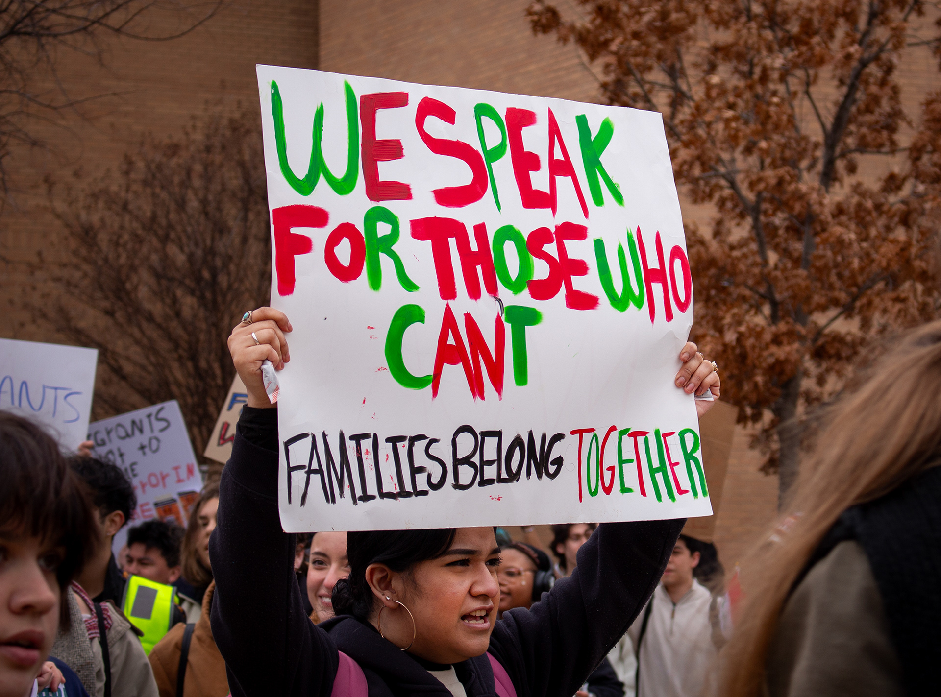 Hand painted signs in vibrant reds and greens, like the Mexican flag, are waving high at the protest against ICE and the deportation of Mexican immigrants on Wednesday, Feb. 12 in the Library Mall on the University of North Texas campus. Many signs said these two phrases: "We speak for those who can't," and, "families belong together." Photo/ Natalie VanDerWal