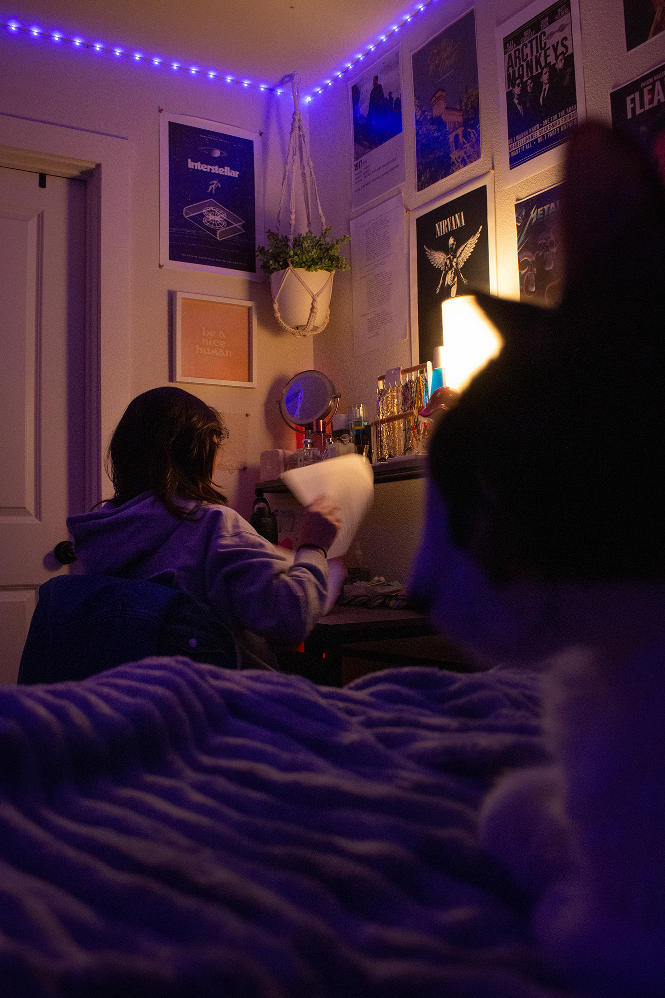 Jaylen Jackson looks through different scripts at her desk in her apartment in Denton, Texas on Feb. 19, 2025. Jackson's room is her safe place, with her cat, plants and many movie posters that cover her walls. Photo/ Natalie VanDerWal