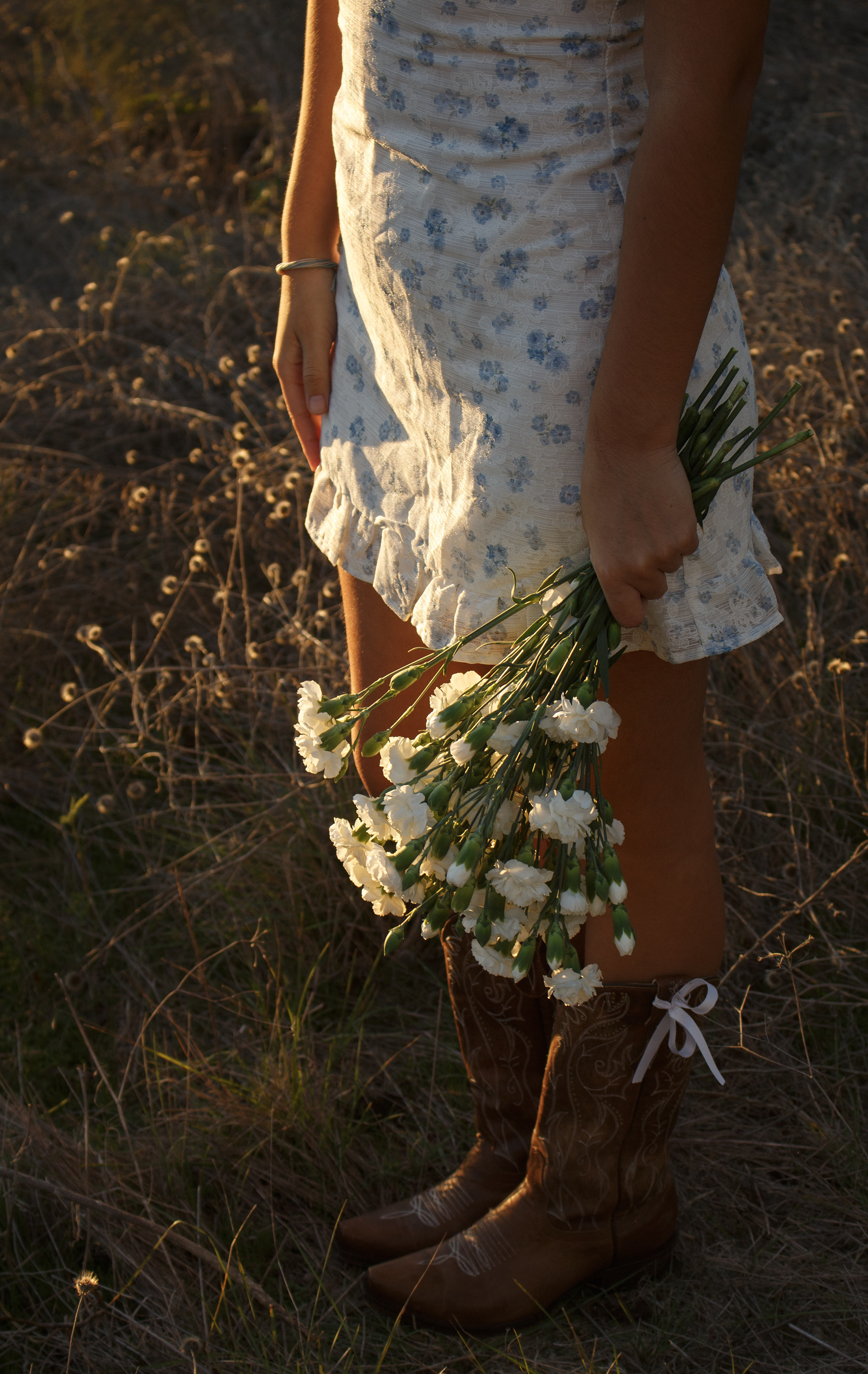 Gabriela Alaniz, Frisco ISD senior, holds a bouquet of white carnations by her side during her senior portrait session on Nov. 10, 2024 in Arbor Hills Nature Preserve. Alaniz became a Certified Nursing Assistant through an FISD program during her senior year, and plans to go into medicine. Photo/ Natalie VanDerWal