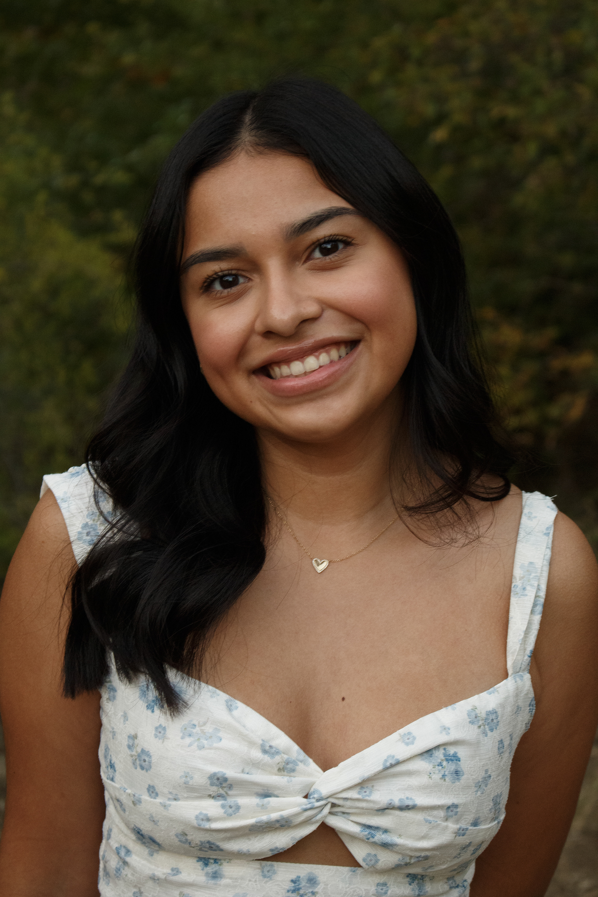 Smiling, Gabriela Alaniz stands posed for an up-close portrait during her senior photo session in Arbor Hills Nature Preserve on Nov. 10, 2024. Photo/ Natalie VanDerWal