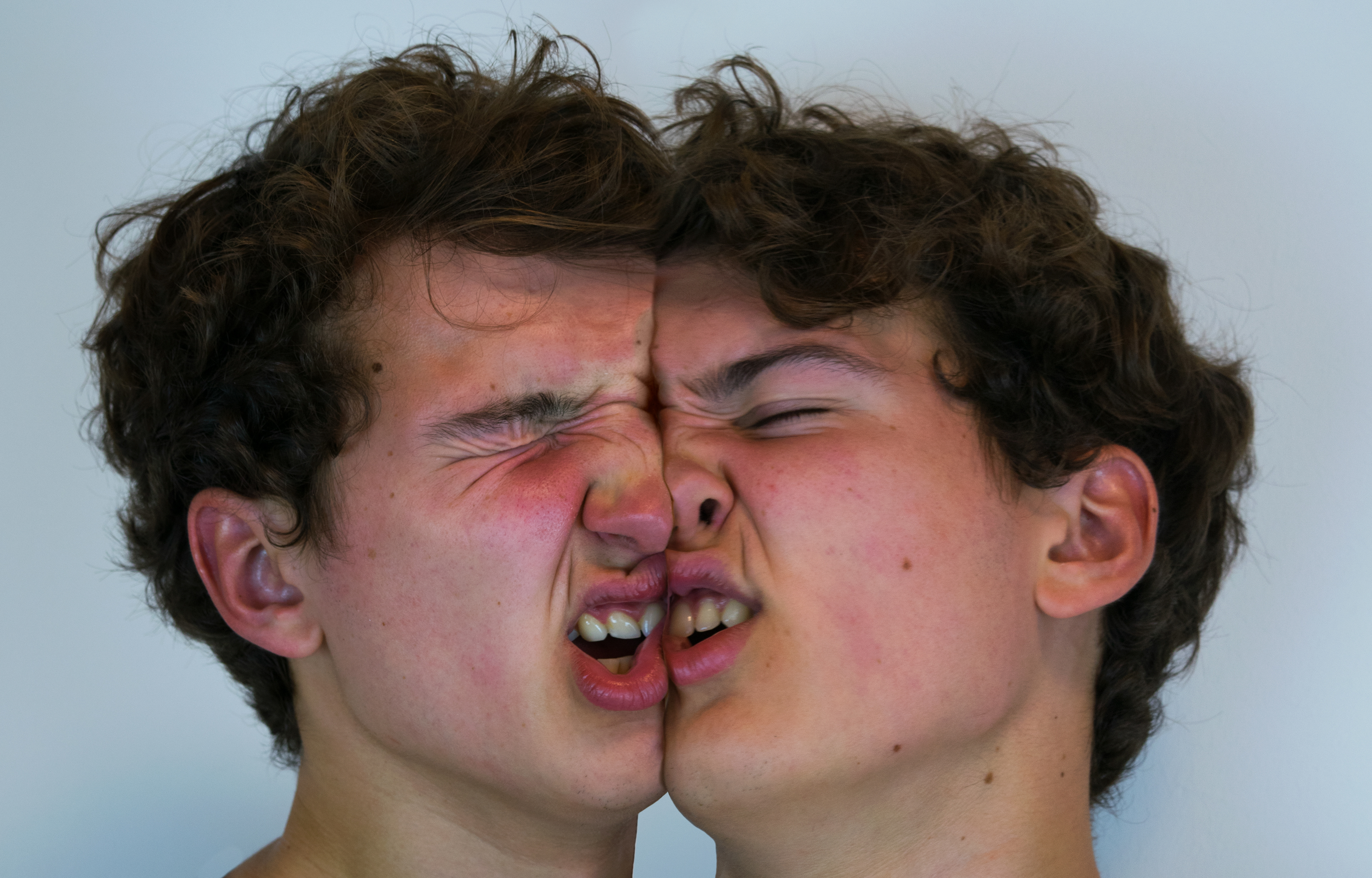 Two doppelgangers banging heads