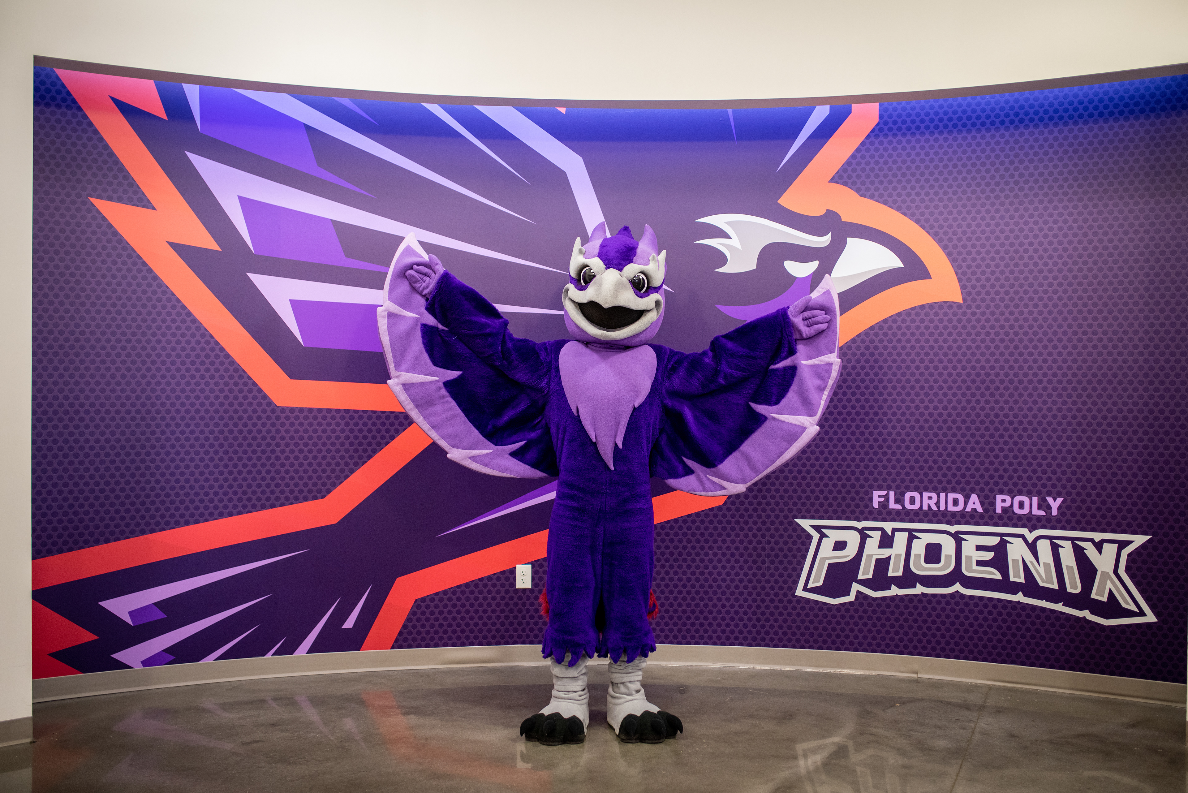 Mascot next to a wrapped wall
