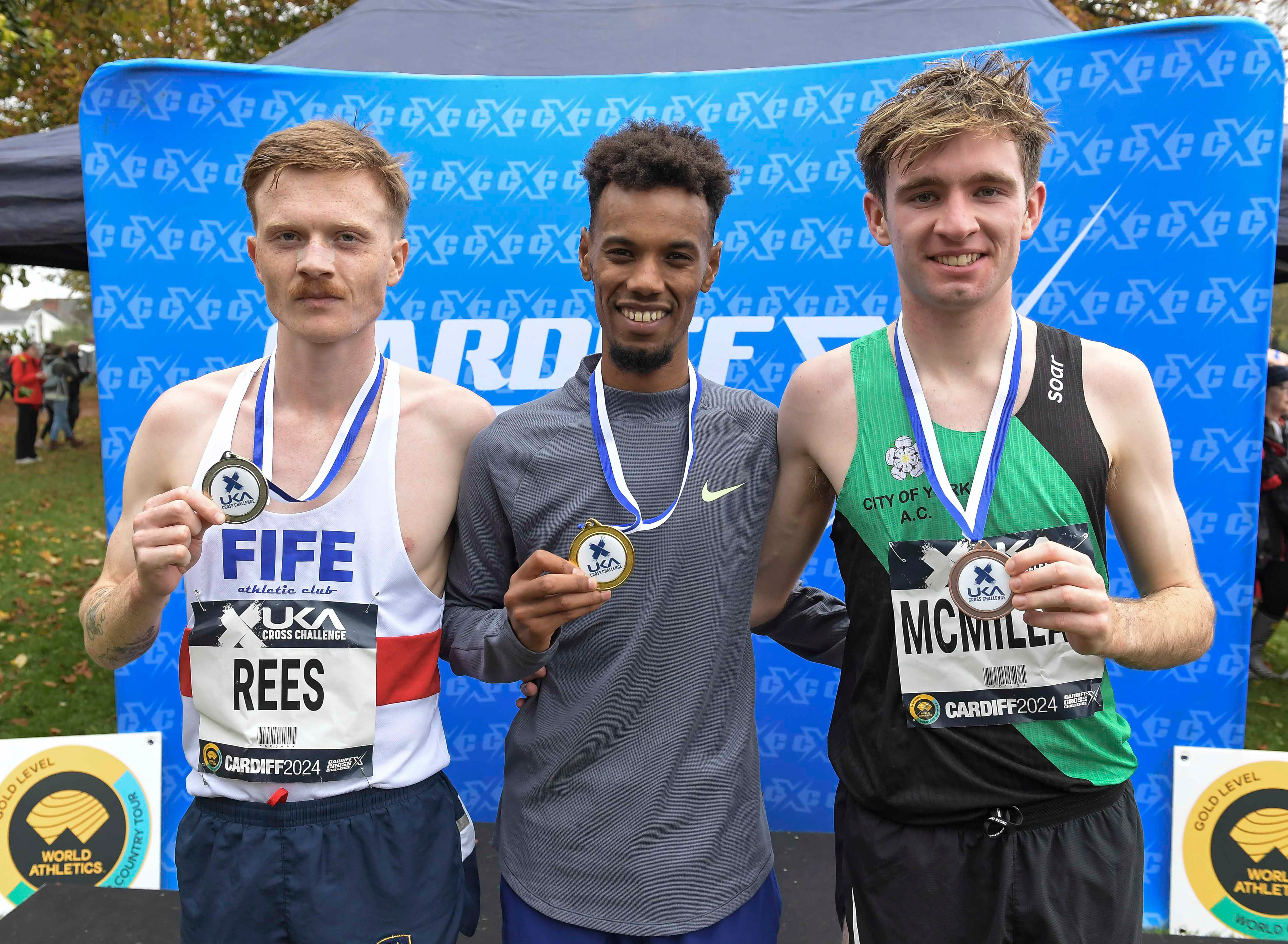 Logan Rees (2nd) Zakariya Mahamed (1st) and  Angus McMillan (3rd) British men’s medal presentation at the Cardiff Cross Challenge inc World Athletics Cross Country Tour (Gold Label), Llandaff Fields, Cardiff, Wales on the 9th November 2024