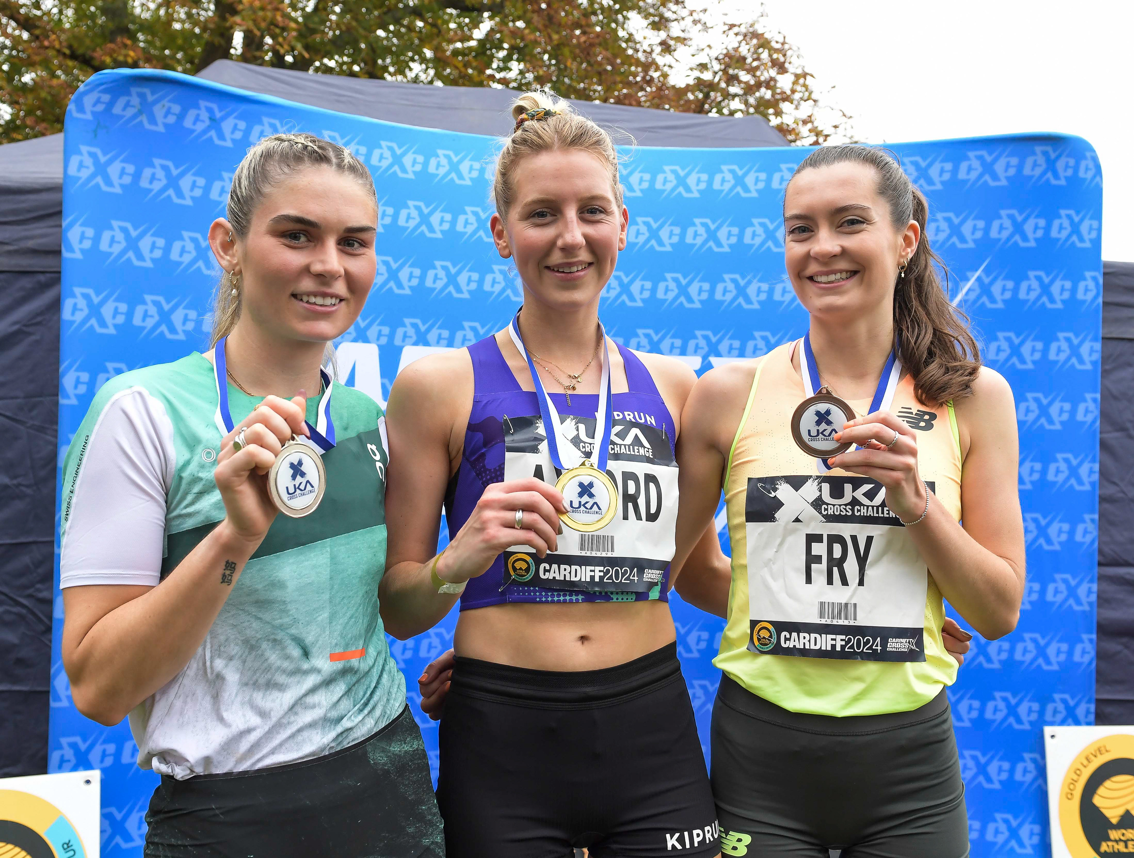 Cari Hughes (2nd) Kate Axford (1st) and Izzy Fry (3rd) senior women’s medal presentation at the Cardiff Cross Challenge inc World Athletics Cross Country Tour (Gold Label), Llandaff Fields, Cardiff, Wales on the 9th November 2024