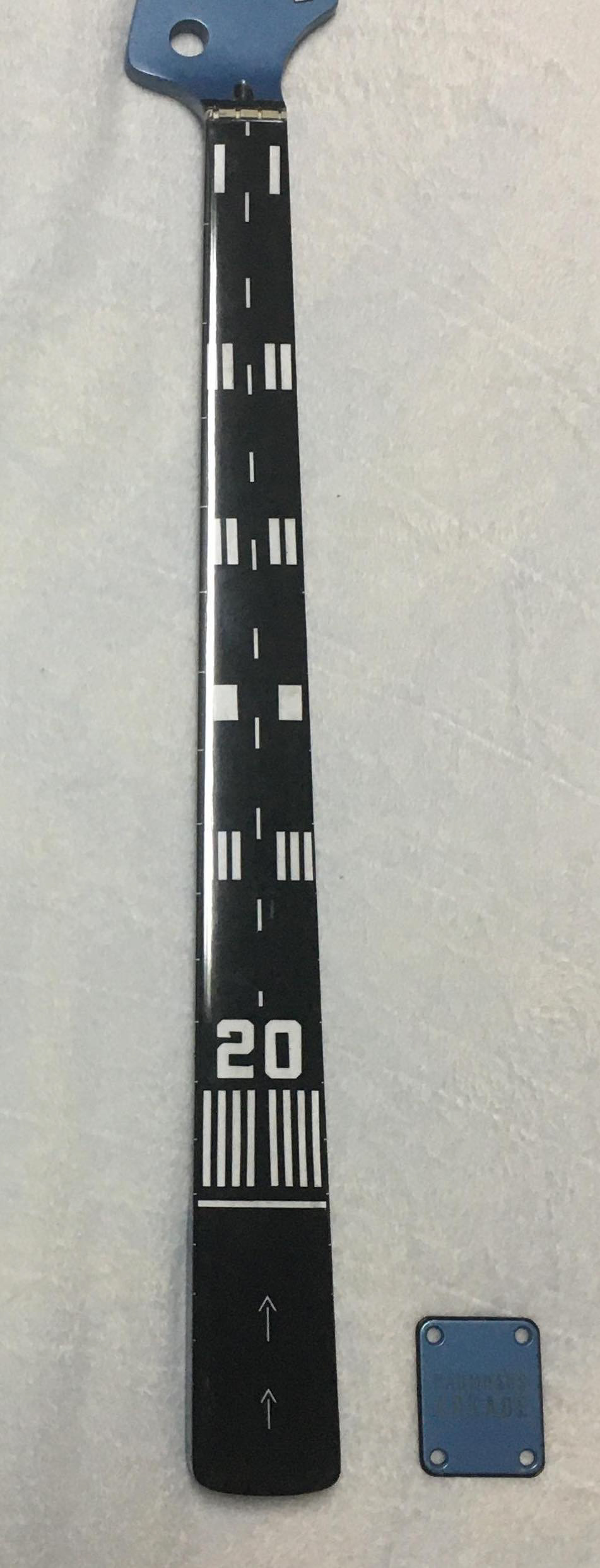 Photo of a bass guitar neck with airport runway markings